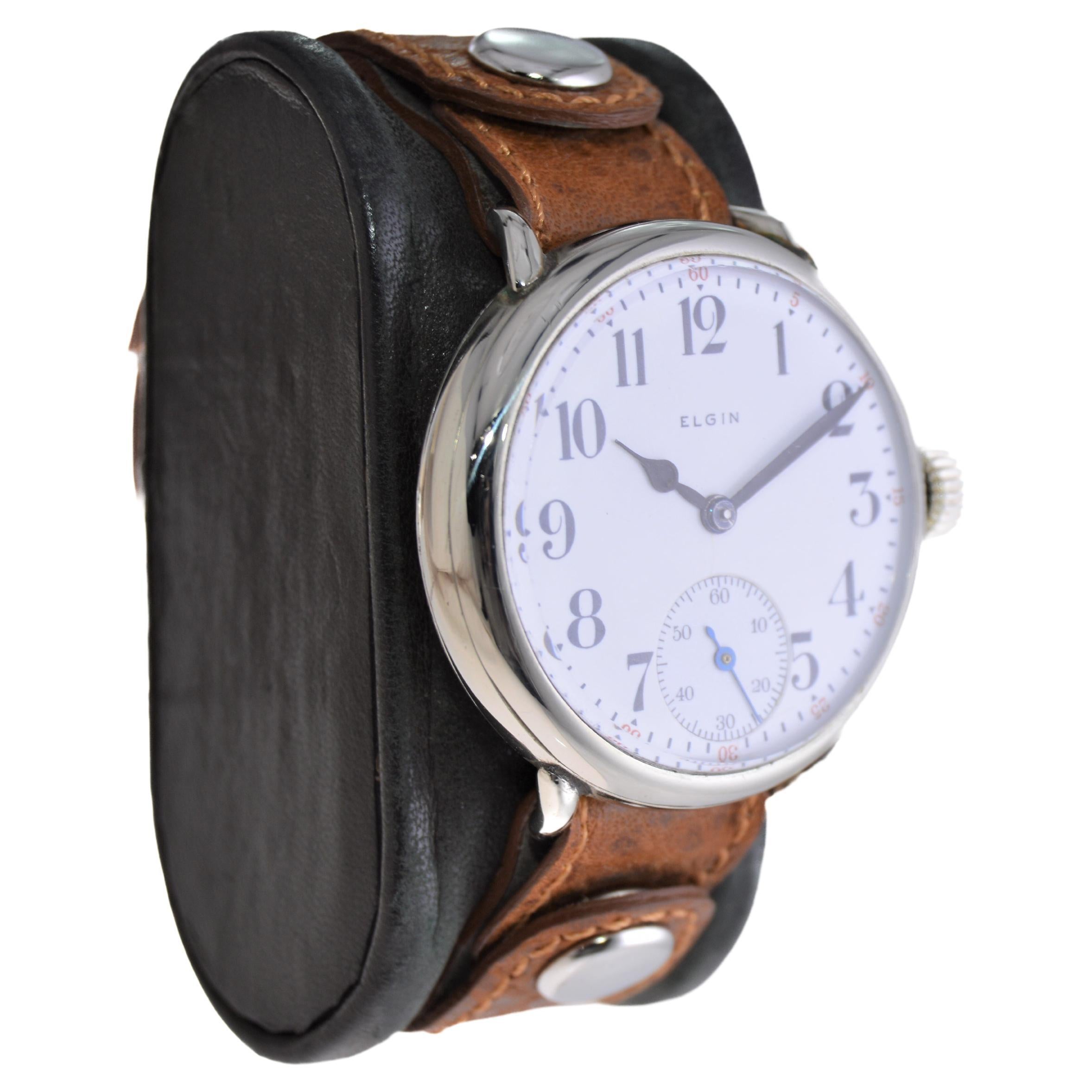 FACTORY / HOUSE: Elgin Watch Company
STYLE / REFERENCE: Campaign Style / W. W. 1 Trench Watch
METAL / MATERIAL: Nickel
CIRCA / YEAR: 1917
DIMENSIONS / SIZE: 40mm Length X 38mm Diameter
MOVEMENT / CALIBER: Manual Winding / 17 Jewels / Caliber 
DIAL /