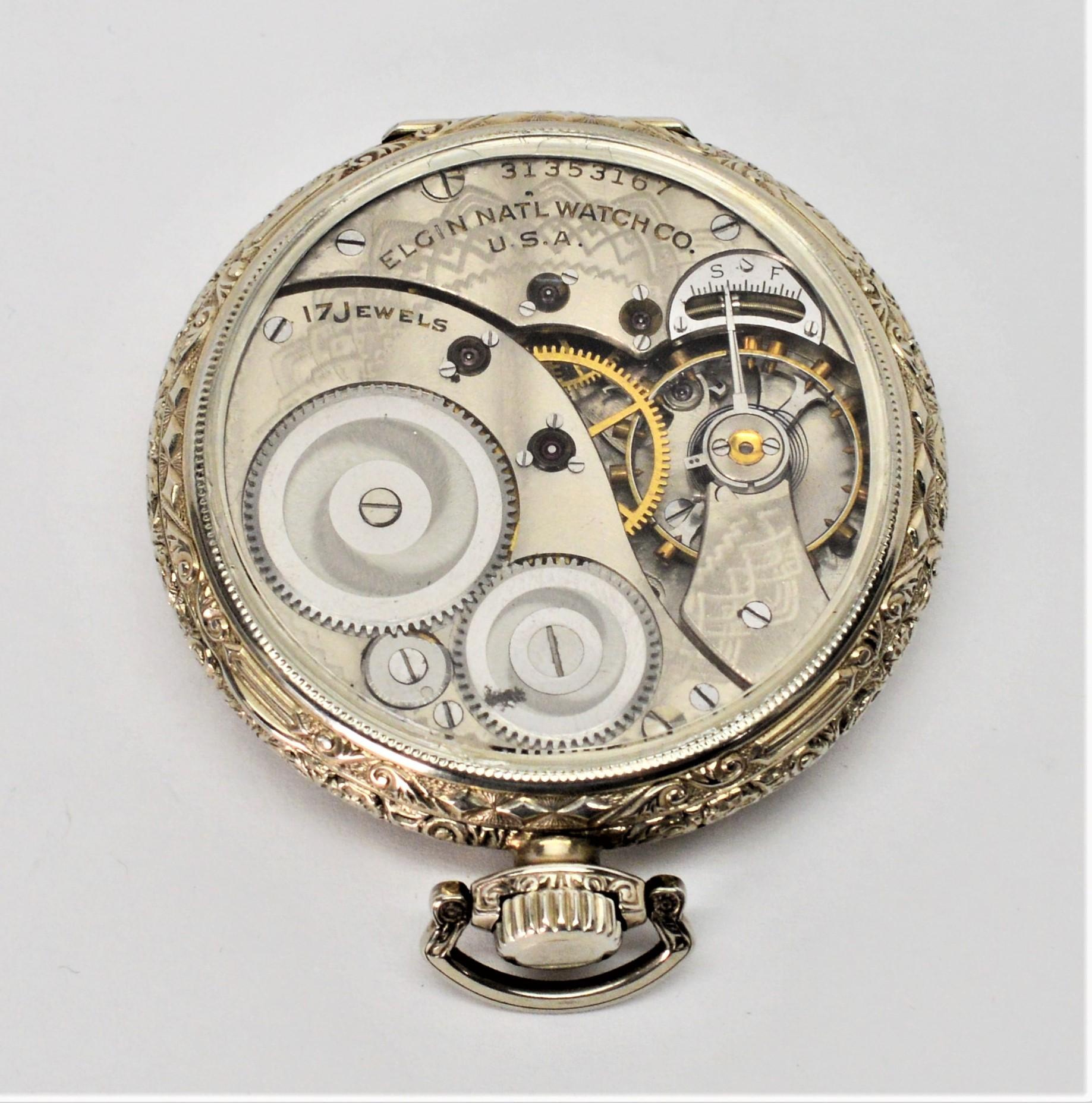 Featuring a unique display back to observe the inner 17 jeweled movement in motion, enjoy this restored Elgin pocket watch. 
Made in 1927, this antique 44mm watch has an ornate nickel case, silver toned decorative engraving and black Arabic numerals