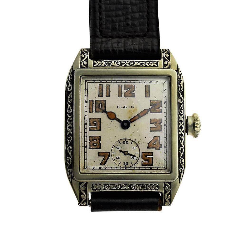 FACTORY / HOUSE: Elgin Watch Company
STYLE / REFERENCE: Art Deco / Tank Style
METAL / MATERIAL: 14Kt. White Gold Filled
CIRCA: 1926
DIMENSIONS: Length 35mm X Width 27mm
MOVEMENT / CALIBER: Manual Winding / 15 Jewels 
DIAL / HANDS: Original Silvered