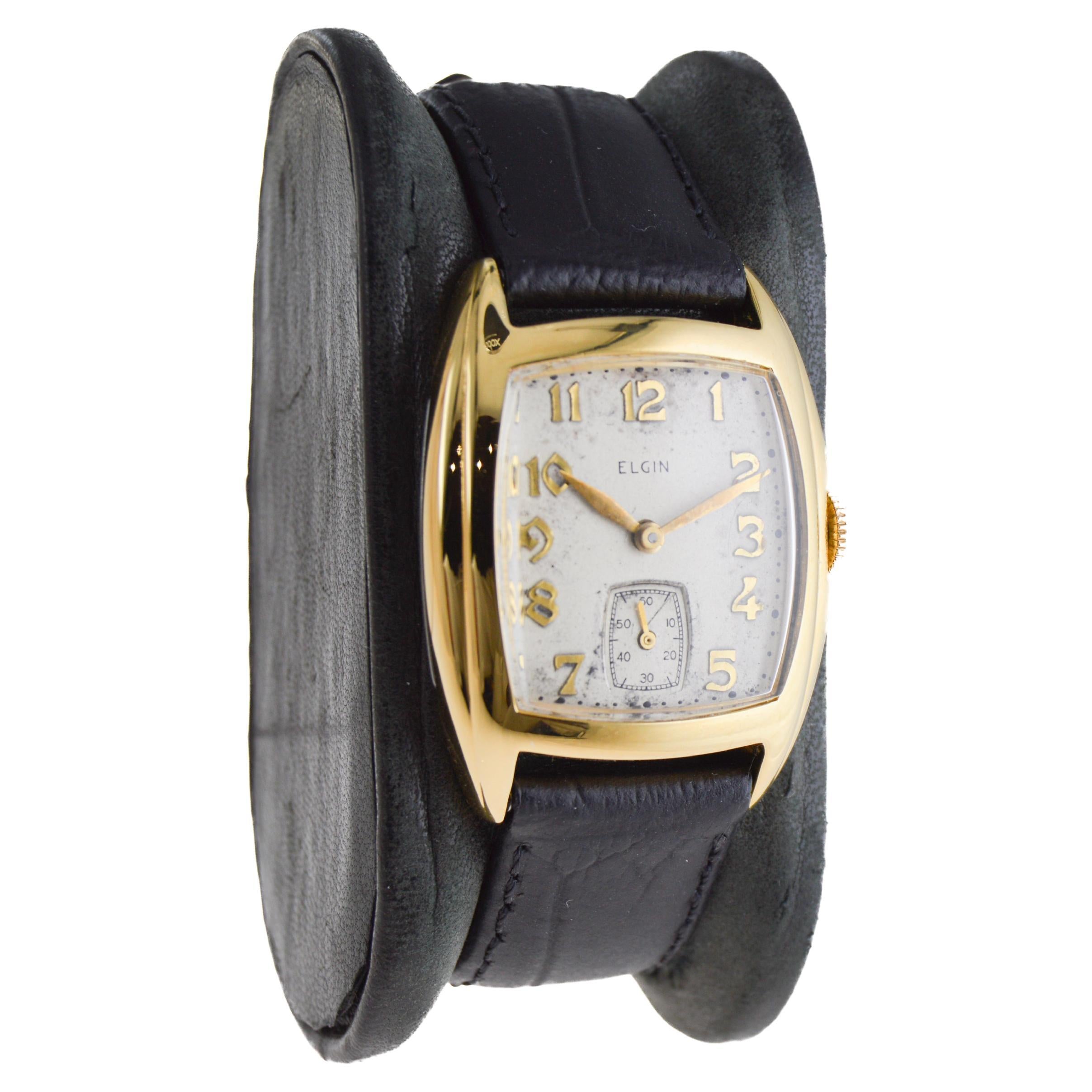 FACTORY / HOUSE: Elgin Watch Company
STYLE / REFERENCE: Art Deco / Tonneau Shape
METAL / MATERIAL: Yellow Gold Filled
CIRCA / YEAR: 1940's
DIMENSIONS / SIZE: Length 36mm X Width 27mm
MOVEMENT / CALIBER: Manual Winding / 15 Jewels / Caliber 10 1/2