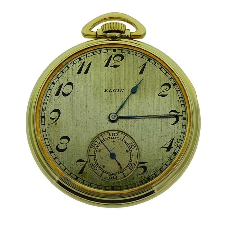 FACTORY / HOUSE: Elgin Watch Co.
STYLE / REFERENCE: Open Faced Pocket Watch
METAL / MATERIAL: Yellow Gold Filled
CIRCA / YEAR: 1911
DIMENSIONS / SIZE: Length & Diameter 44mm
MOVEMENT / CALIBER: Manual Winding / 15 Jewels 
DIAL / HANDS: Original