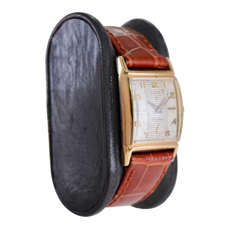 FACTORY / HOUSE: Elgin Watch Company
STYLE / REFERENCE: Art Deco Tank Style
METAL / MATERIAL: Yellow Gold Filled 
CIRCA / YEAR: 1950's
DIMENSIONS / SIZE: Length 36mm X Width 23mm
MOVEMENT / CALIBER: Manual Winding / 19 Jewels / Caliber 772
DIAL /