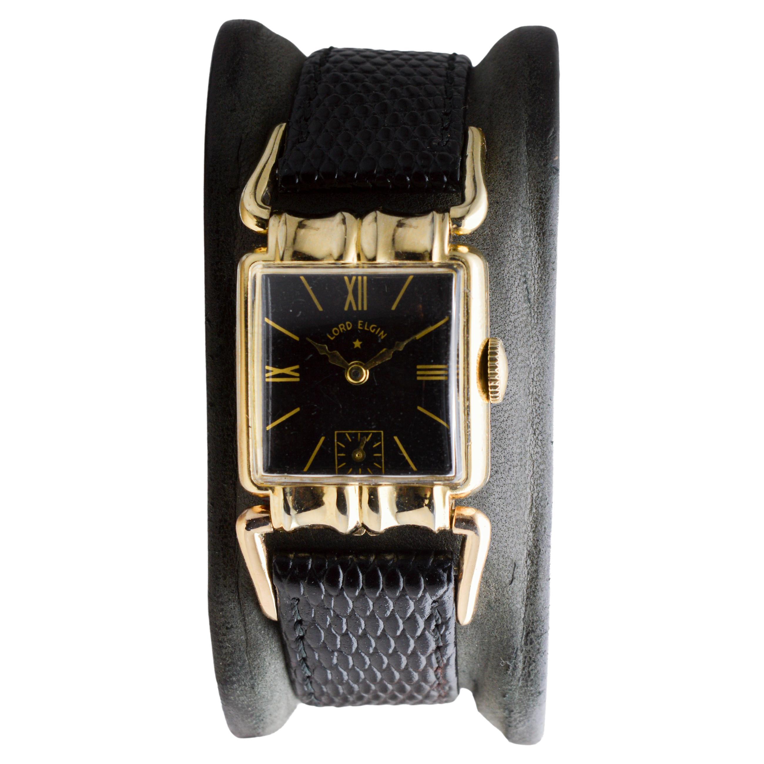 Femenino o masculino Reloj Art Déco Elgin relleno de oro amarillo con rara esfera negra  Ganchos articulados en venta