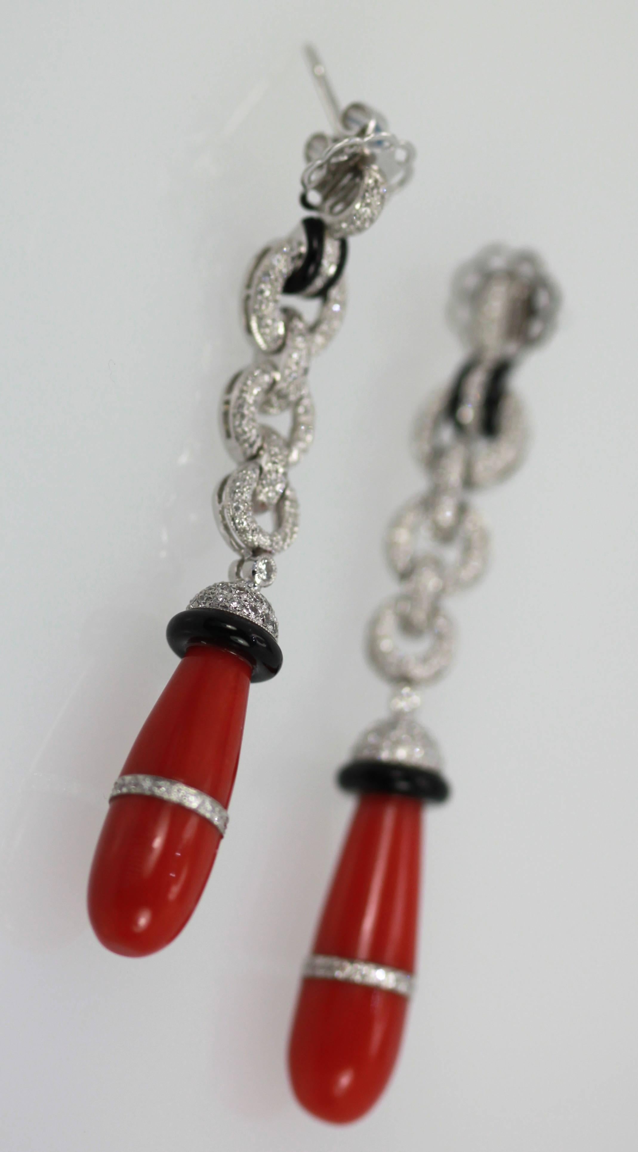 Drop Dead gorgeous Eli Frei Coral Earrings are amazing.  Each Earring features a butterfly post with Pave Diamonds thoughout, gorgeous natural Coral teardrops with a band of Diamonds aroud each Coral stone.  Onyx circle on top of Coral and at top of