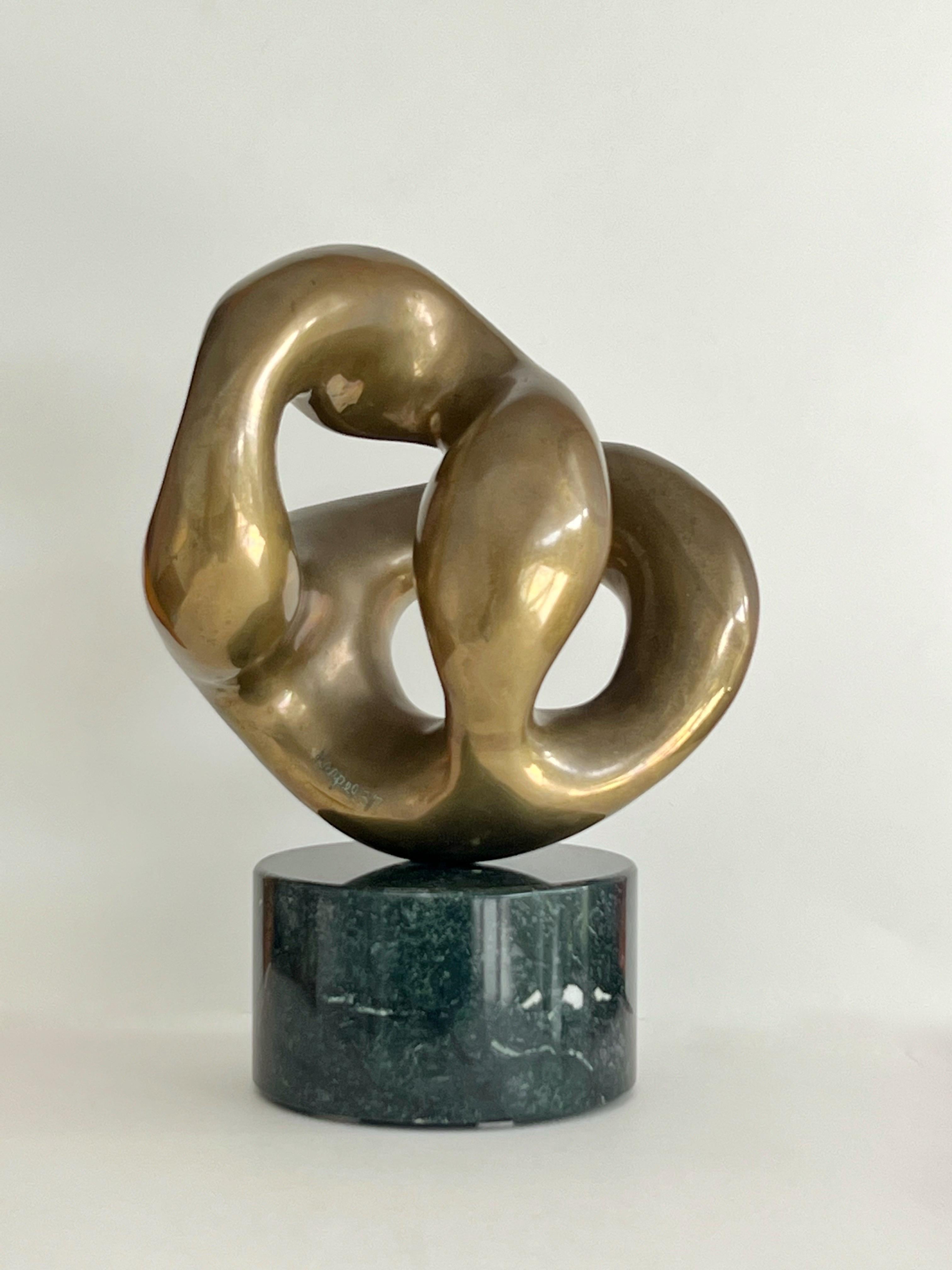 A solid abstract bronze sculpture on marble base by Eli Karpel. An amorphous biomorphic shape that seams to transform as you change perspective. Number 3 of a small edition of seven. On its original marble base. Bronze without base is 11.5
