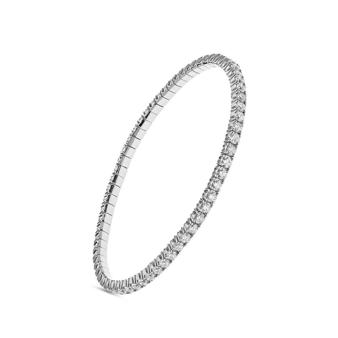 This stunning stretch bangle features four-prong set round brilliant diamonds totaling 4.64 carats. A versatile and elegant diamond tennis bracelet, this piece fits many wrist sizes and is meticulously manufactured in Italy, making it a must-have