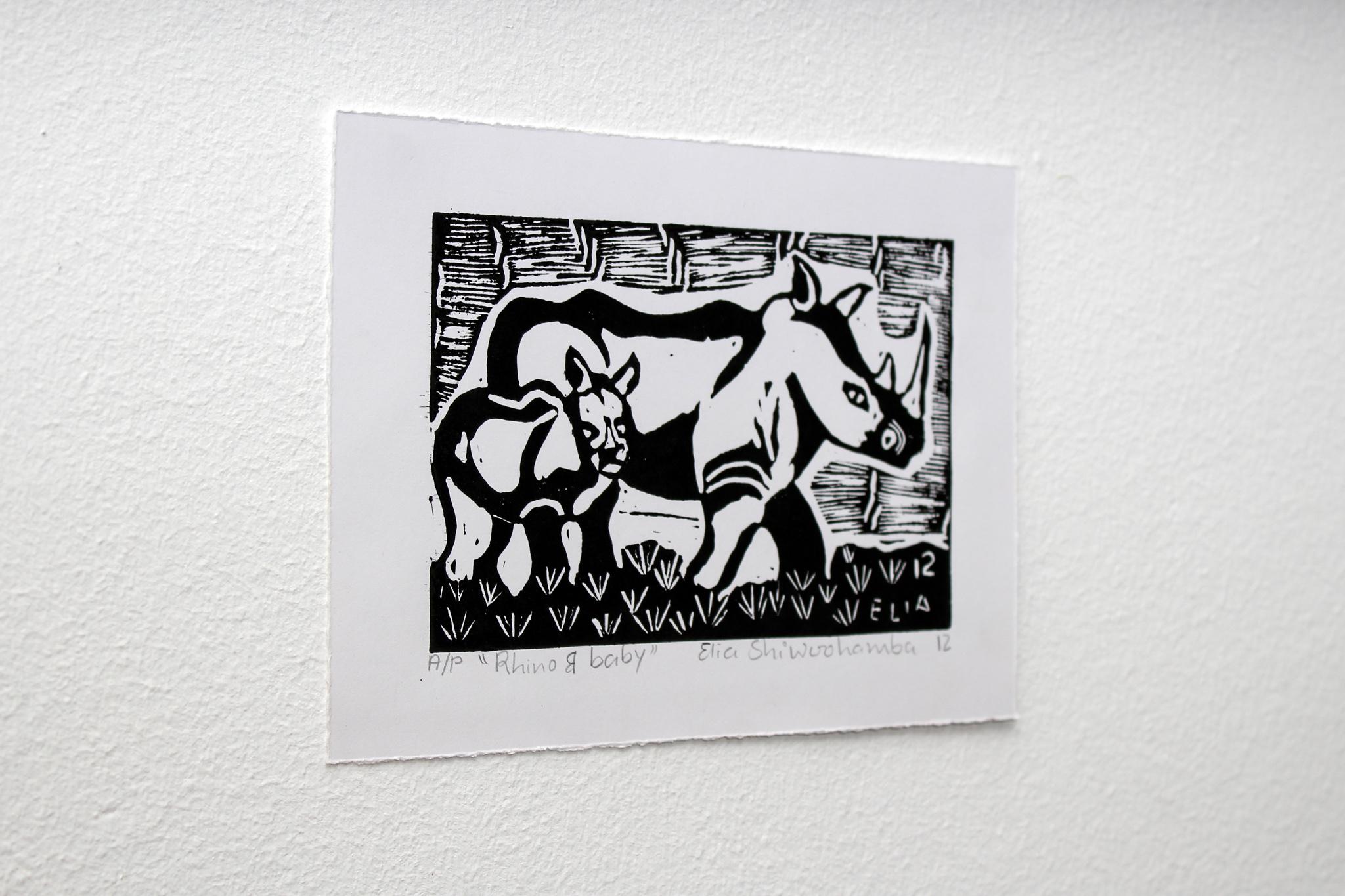 Rhino and baby, Linoleum block prints on paper.

Elia Shiwoohamba was born in 1981 in Windhoek, Namibia. He graduated from the John Muafangejo Art Centre in Windhoek in 2006. Specialising in printmaking and sculpture, Shiwoohamba works as a
