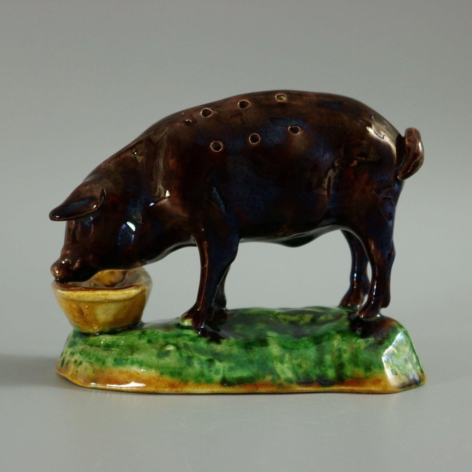 Elias Portuguese Palissy Majolica toothpick holder which features a pig, feeding from a trough. Colouration: brown, green, ochre, are predominant. The piece bears maker's marks for the Elias pottery.