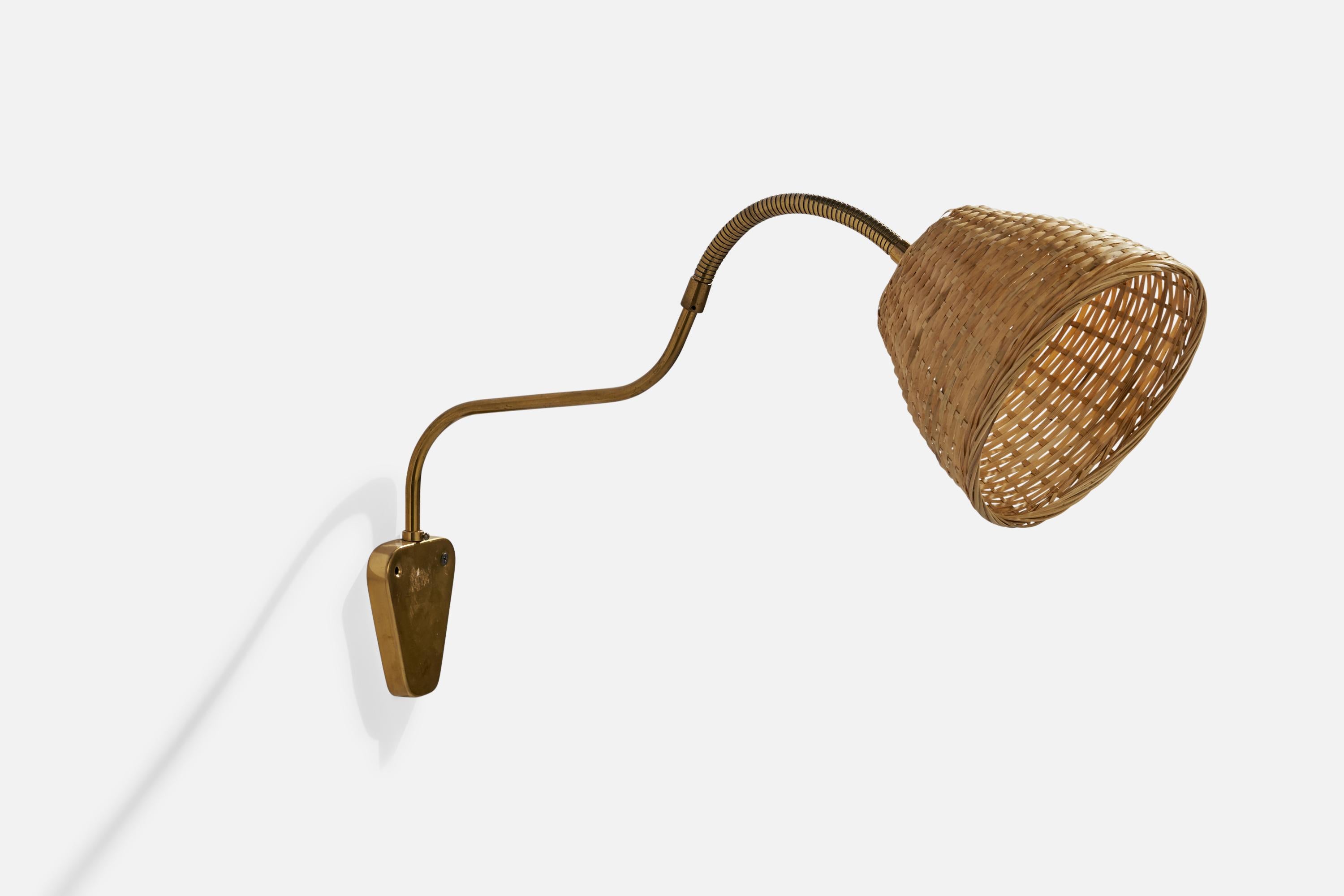 An adjustable brass and rattan wall light designed and produced by Elidus, Sweden, 1940s.

Dimensions variable.

Overall Dimensions (inches): 24” H x 13” W x 15” D
Back Plate Dimensions (inches): 4”  H x 3.75” W x .75”  D
Bulb Specifications: E-26