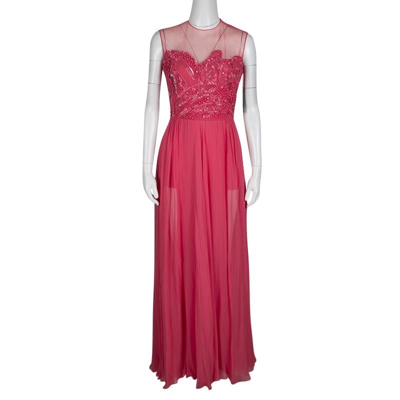 Look breath-taking and picture-perfect as you don this sleeveless gown from Elie Saab which creates a strikingly feminine look with its flawless silhouette. The fitted bodice, embellished exquisitely with beads and sequins, goes sheer towards the