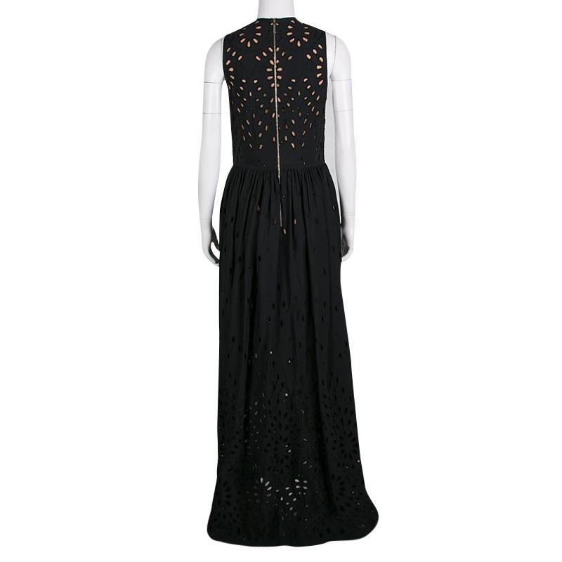 Long dramatic gowns with laser-cut to floral effect were the highlight of Elie Saab's Spring-Summer 2016 Ready to wear collection. This maxi dress is gloriously crafted with a cotton blend in black color featuring eyelet embroidery all over. It has