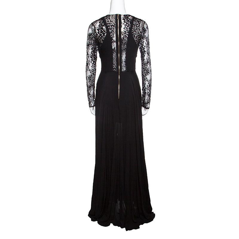 This scintillating black gown from Elie Saab will take your breath away. The enchanting creation is made of a rich silk blend and features a creative lace panel detailing. It flaunts a pleated silhouette, a plunging neckline, long sleeves and a zip