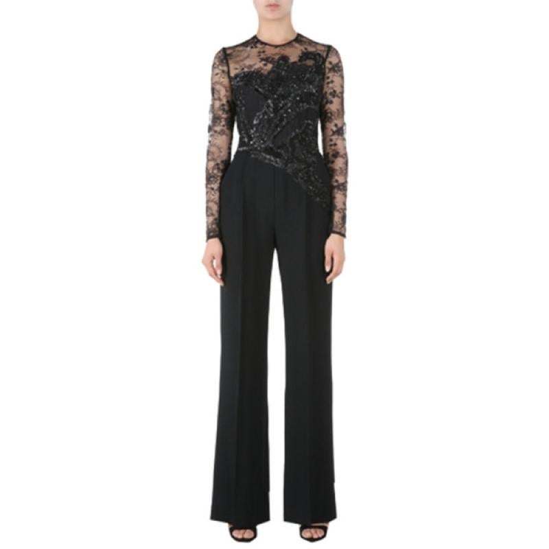 Part of the stunning SS '15 collection, this Elie Saab jumpsuit will certainly dress to impress. It features a straight cut with a round neckline and long lace sleeves that give it a sensuous appeal. The strapless black fabric is designed with