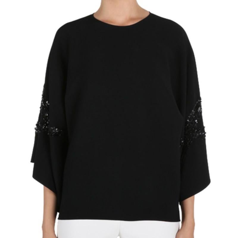 Whether worn to a morning brunch or an evening dinner, this Elie Saab AW14 top will leave you at the top of the social ladder. Its classic black color is designed with a round neckline and wide sleeves embellished with black sequins. This top