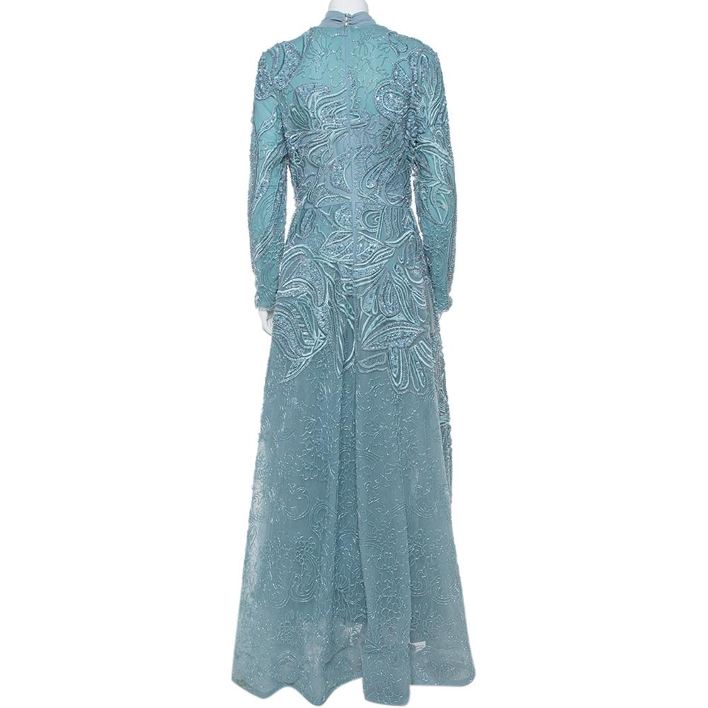 This stunning dress by Elie Saab, a label known for its feminine head-turner creations. The dress is made from tulle with a structured silhouette and stylish sequins details. This full sleeves dress comes with a rear zip closure. Accented with
