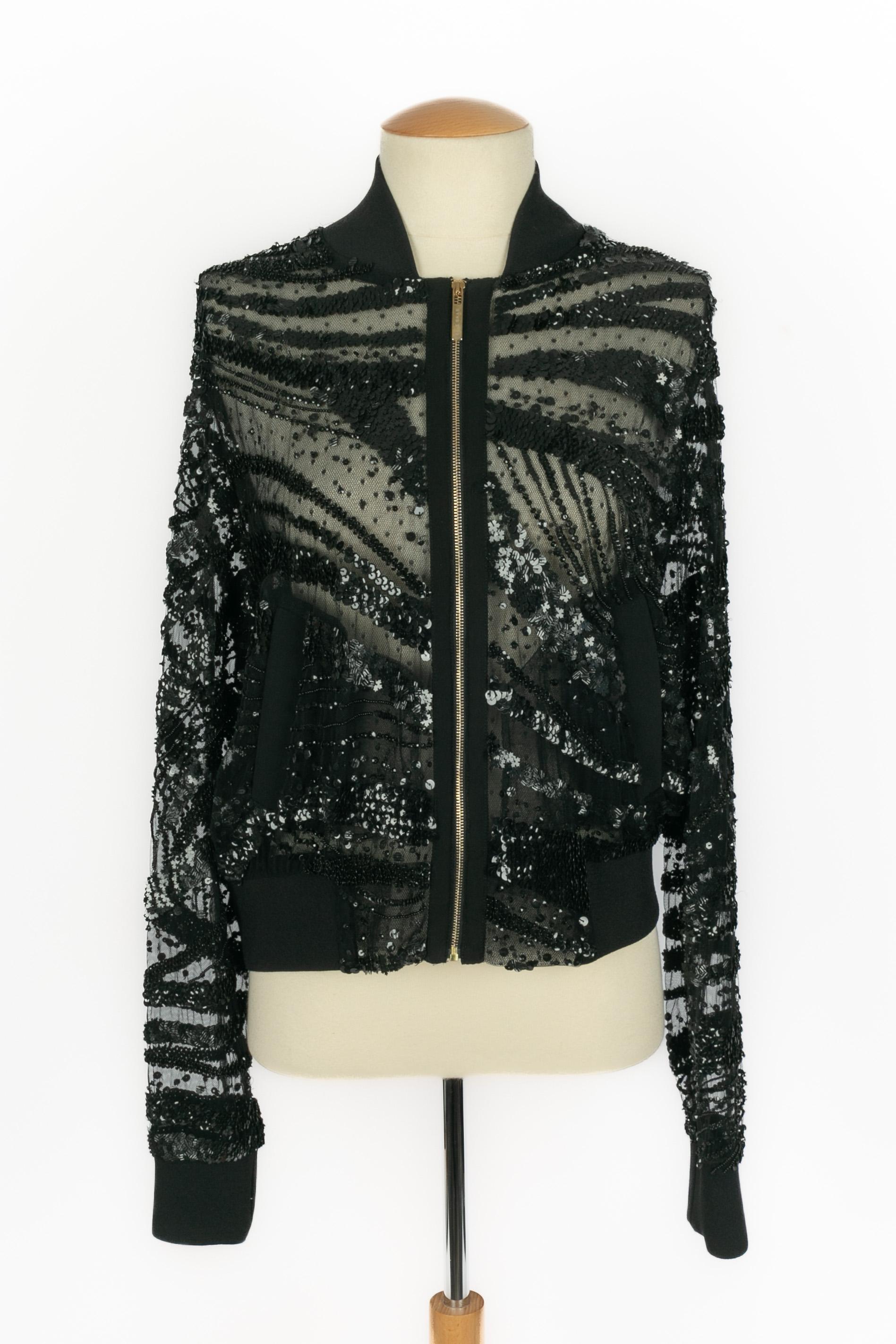 ELIE SAAB - Transparent black bomber jacket embroidered with black pearls and sequins. Size 40FR indicated.

Condition:
Very good condition

Dimensions:
Shoulder width: 44 cm - Chest: 56 cm - Sleeve length: 72 cm - Length: 57 cm

SKU:FV237