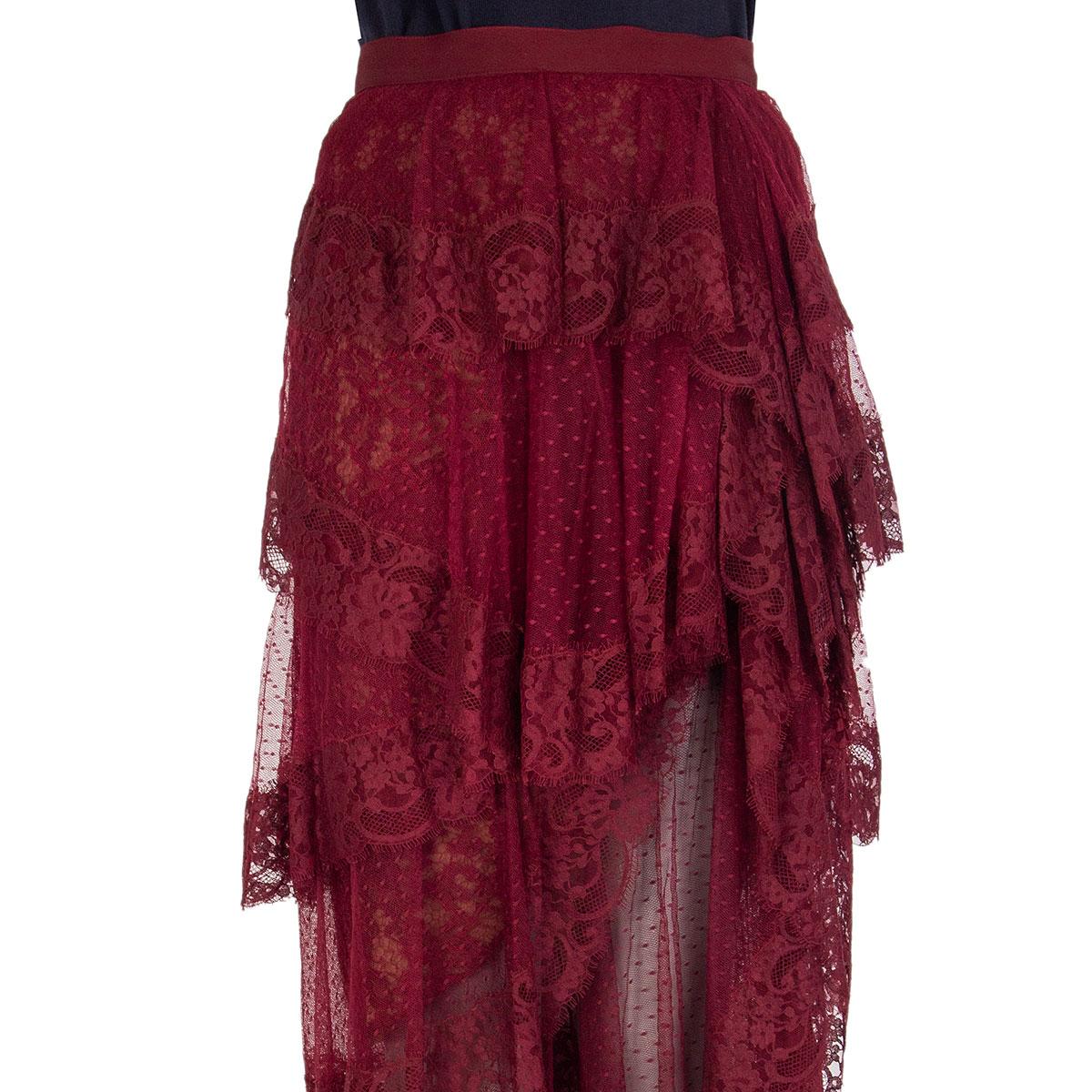 100% authentic Elie Saab tiered chantilly lace midi skirt in burgundy cotton (56%), nylon (23%) and polyamid (21%). Made from layers of lace and Swiss-dot tulle, this semi-sheer piece is lined through the mid-thigh and falls to an asymmetric