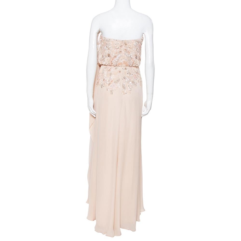 Sway like a dream in this evening dress from Elie Saab. Tailored to perfection, the strapless creation has beautiful embellishments on the bodice, a draped silhouette, and a flowy skirt. Pair it up with simple heels and a pastel clutch.

