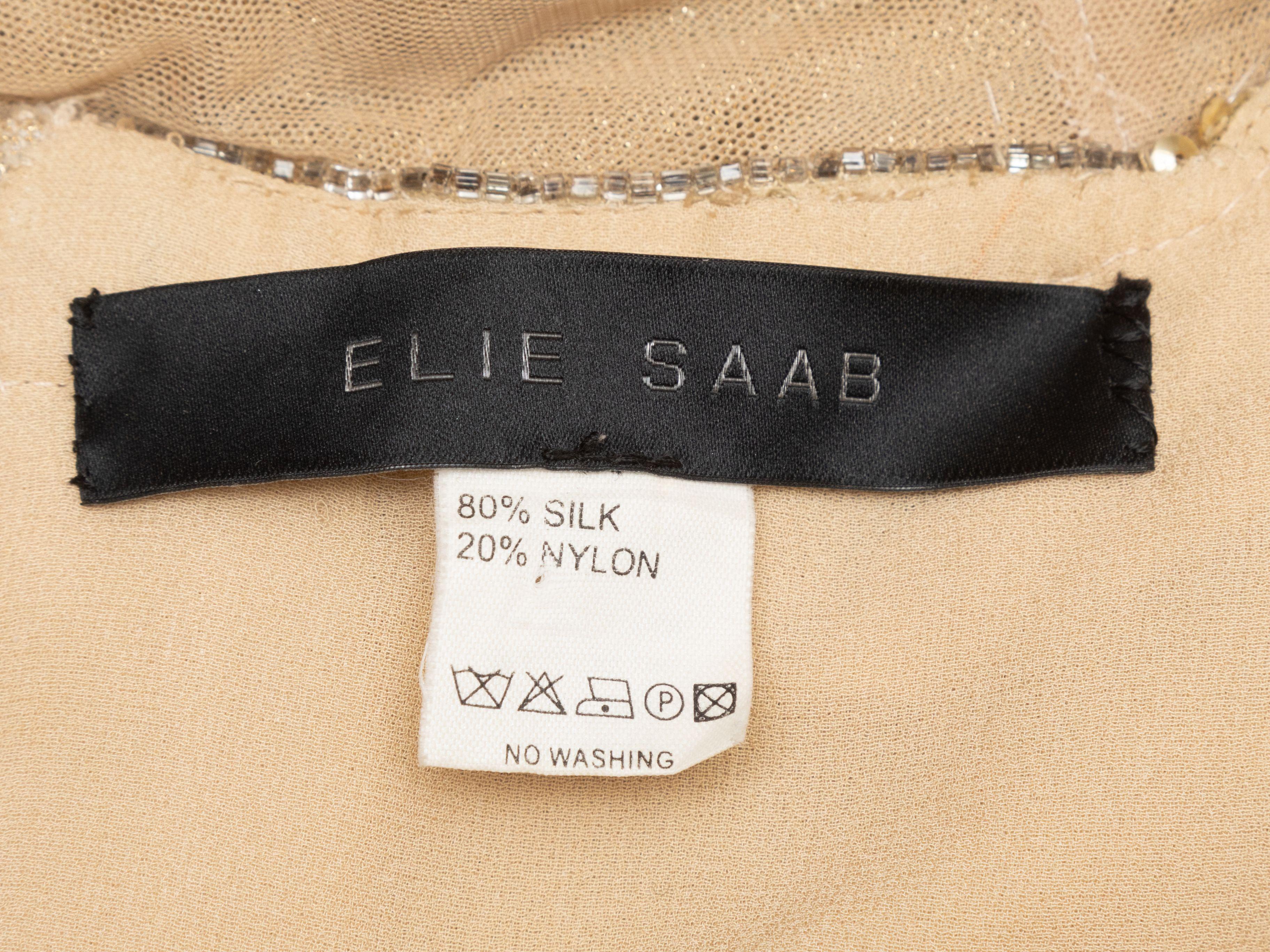 Product Details: Gold silk sequined and beaded cocktail halter dress by Elie Saab. V-neckline. Zip closure at center back. 32