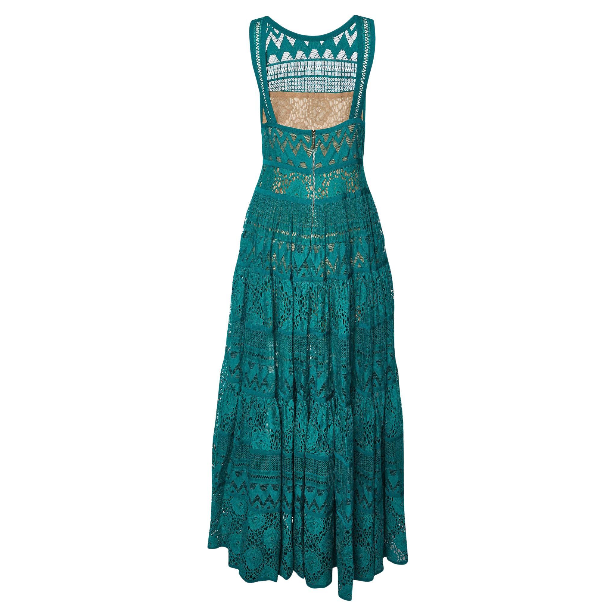 Immerse yourself in the enchanting allure of the Elie Saab dress. Crafted with meticulous attention to detail, this ethereal garment boasts delicate lacework that gracefully adorns its sleeveless silhouette. Its verdant hue evokes a sense of natural