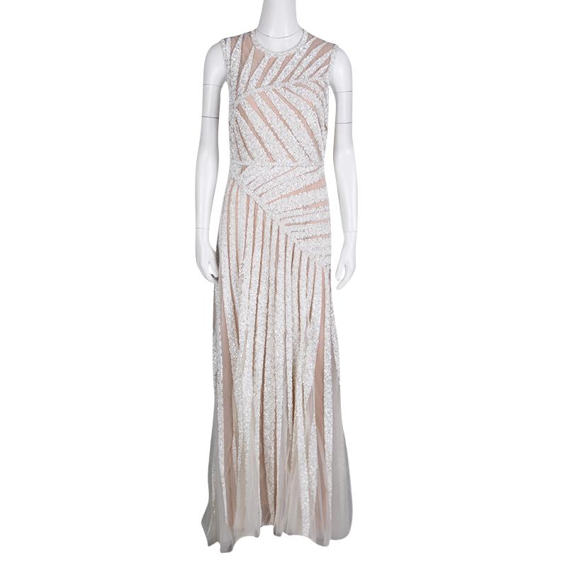 Beautifully embellished with sequins and beads creating a palm leaf pattern, this sleeveless tulle gown from Elie Saab is ideal for special events. The floor-grazing length and muted ivory color combine to make it as sophisticated as elegant it is.