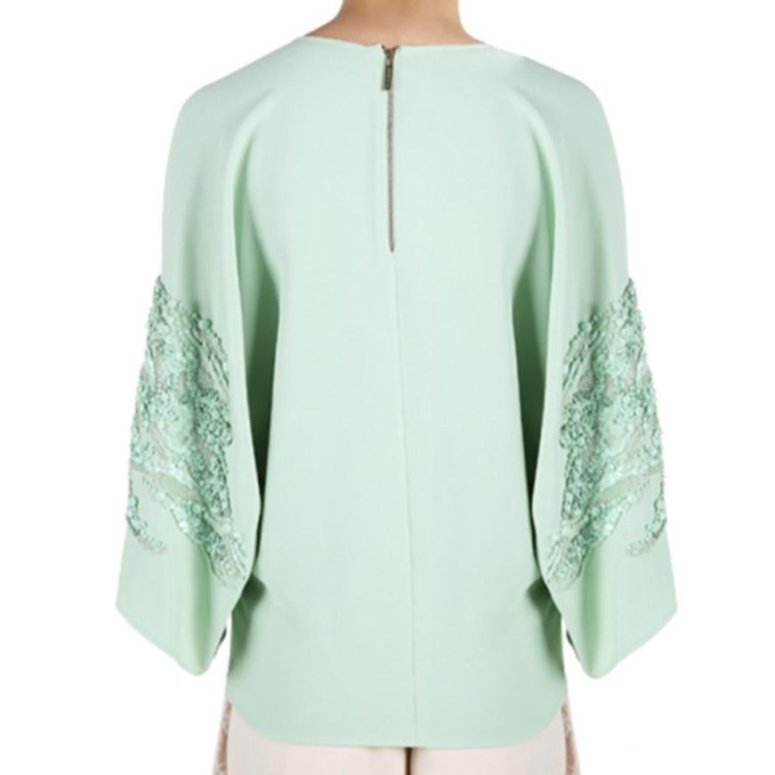 Whether worn to a morning brunch or an evening dinner, this Elie Saab AW14 top will leave you at the top of the social ladder. Its bright mint shade is designed with a round neckline and wide sleeves embellished with matching sequins. This top