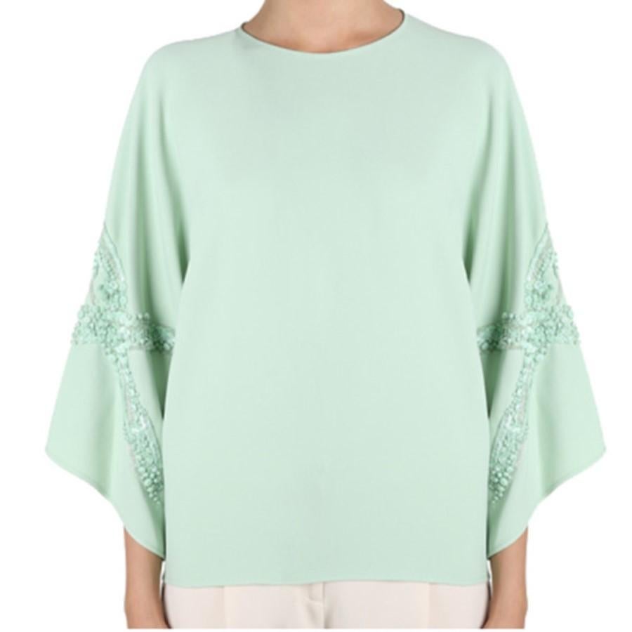 Whether worn to a morning brunch or an evening dinner, this Elie Saab AW14 top will leave you at the top of the social ladder. Its bright mint shade is designed with a round neckline and wide sleeves embellished with matching sequins. This top