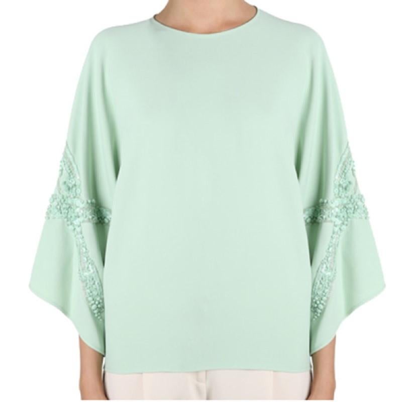 Whether worn to a morning brunch or an evening dinner, this Elie Saab AW14 top will leave you at the top of the social ladder. Its bright mint shade is designed with a round neckline and wide sleeves embellished with matching sequins. This top