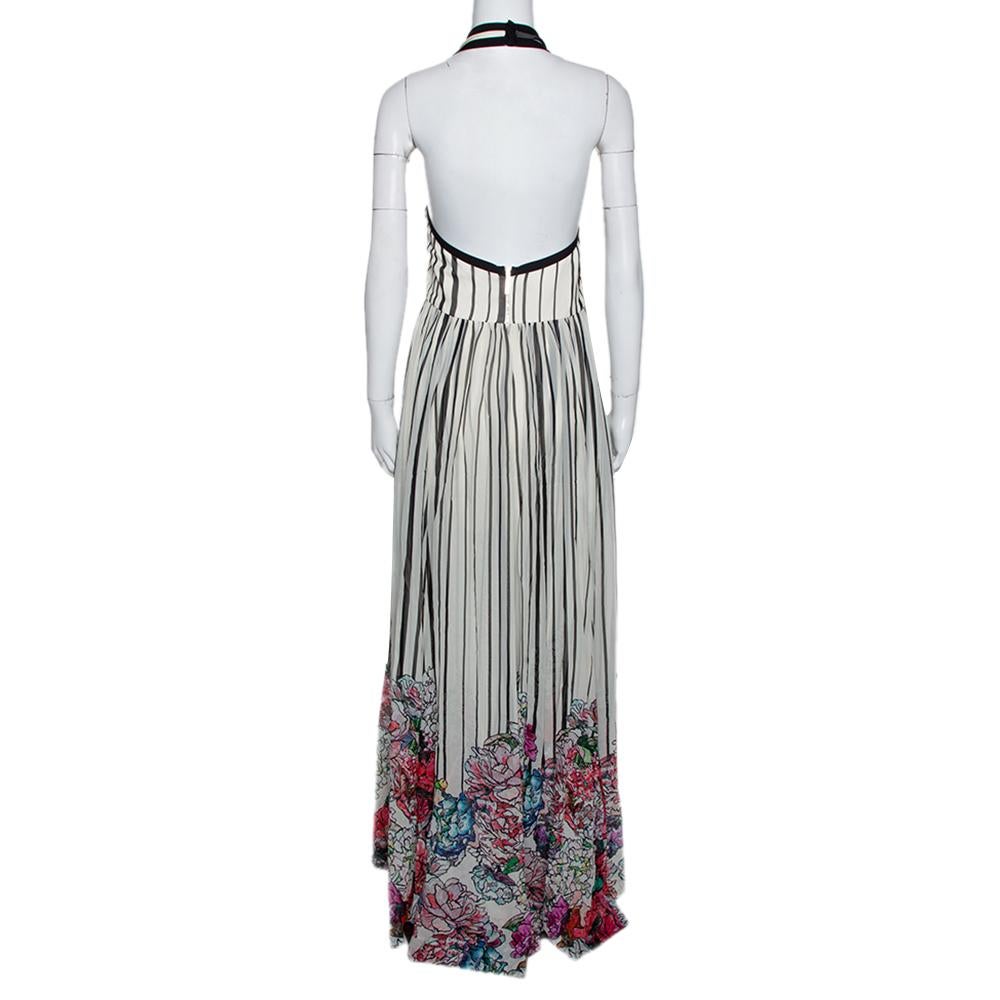 Tailored to help you attain an elegant look, this monochrome maxi dress from Elie Saab is a great pick. It is made entirely from silk and designed with a halter neckline and a zip closure at the back. The full-length creation has a cinched waist and
