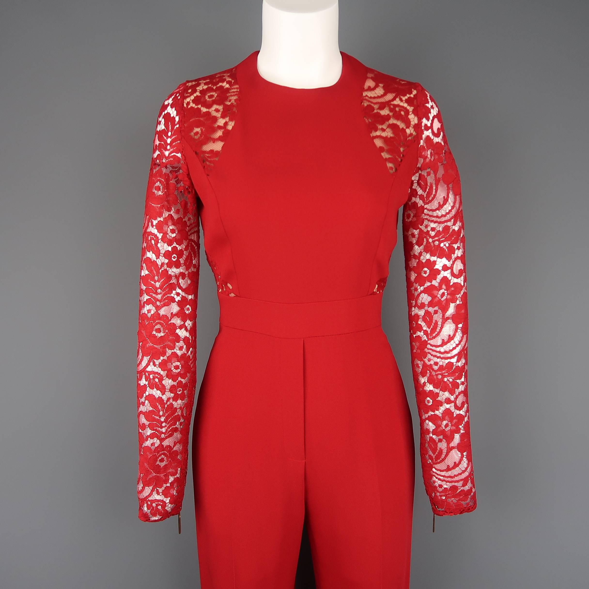 Elie Saab jumpsuit comes in red crepe material with lace long sleeves with zip cuffs, beige lined lace panels, and high rise flared flat front pants. With red leather skinny belt. Made in Italy.
 
Excellent Pre-Owned Condition.
Marked: FR 36
