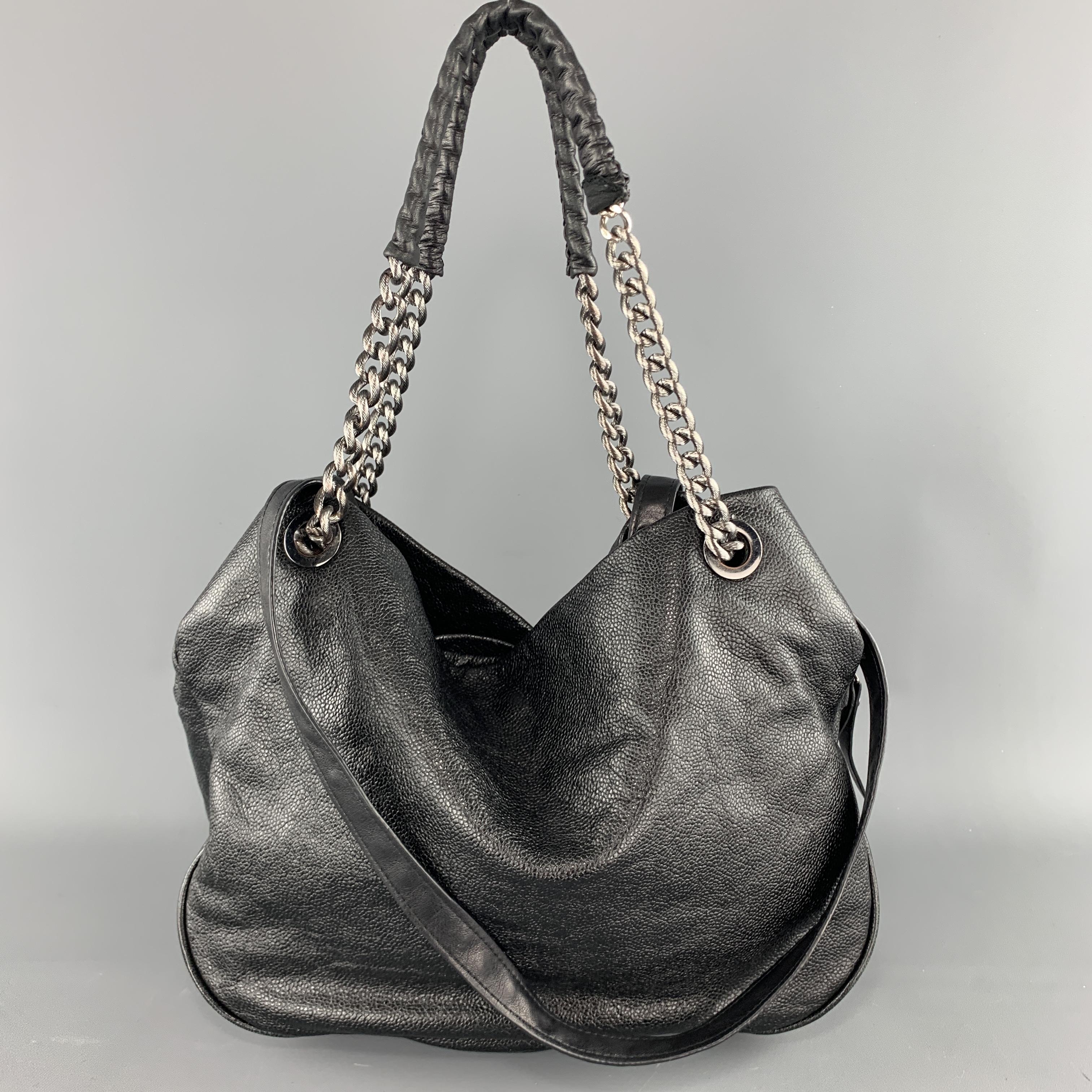 ELIE TAHARI purse comes in black textured leather with chain straps, leather shoulder straps, zip center compartment, and side snap compartments. 

Excellent Pre-Owned Condition.

Measurements:

Length: 14 in.
Width: 6 in.
Height: 11 in.
Drop: 16 in.