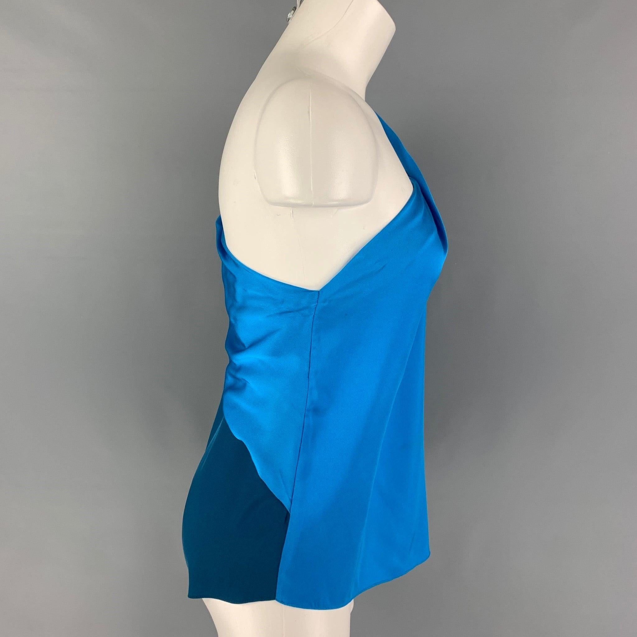 ELIE TAHARI blouse comes in a cobalt & blue two toned silke featuring a one shoulder design, slit sleeve detail, and spaghetti straps.
Good
Pre-Owned Condition. Light wear. As-is.  

Marked:   S 

Measurements: 
  Bust: 33 inches Sleeve: 16.5 inches
