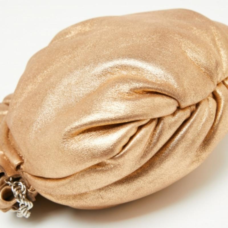 This Elie Tahari bag is meant to complement your evening soirées. It is made of metallic gold leather—for a glam appeal—and added with a snap button closure and a shoulder chain. The bag can be carried across the body or as a clutch.