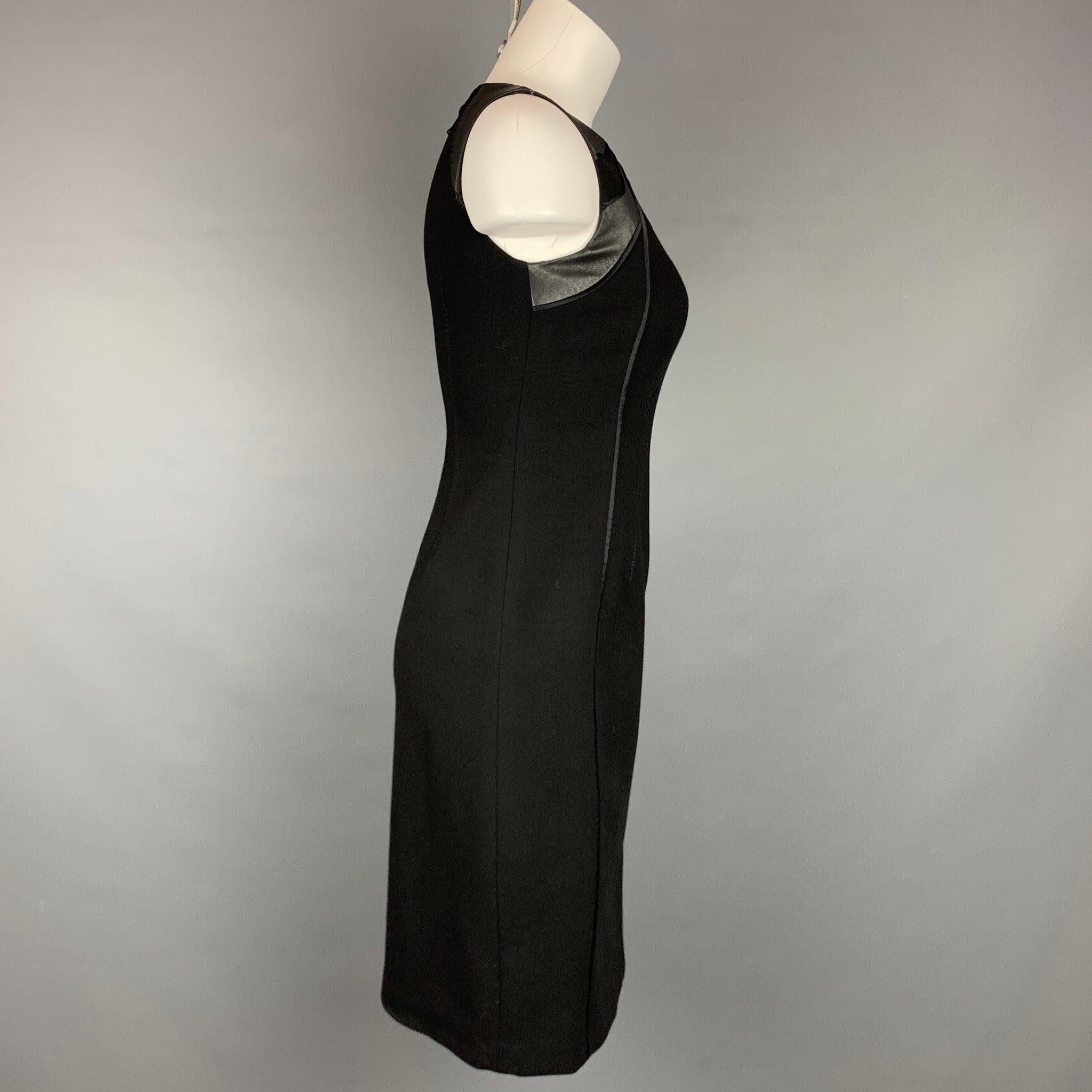 ELIE TAHARI dress comes in a black viscose blend with a leather trim featuring a shift style, sleeveless, top stitching, and a back zipper closure.
Very Good
Pre-Owned Condition. 

Marked:   US 0 

Measurements: 
 
Shoulder: 13 inches  Bust: 30