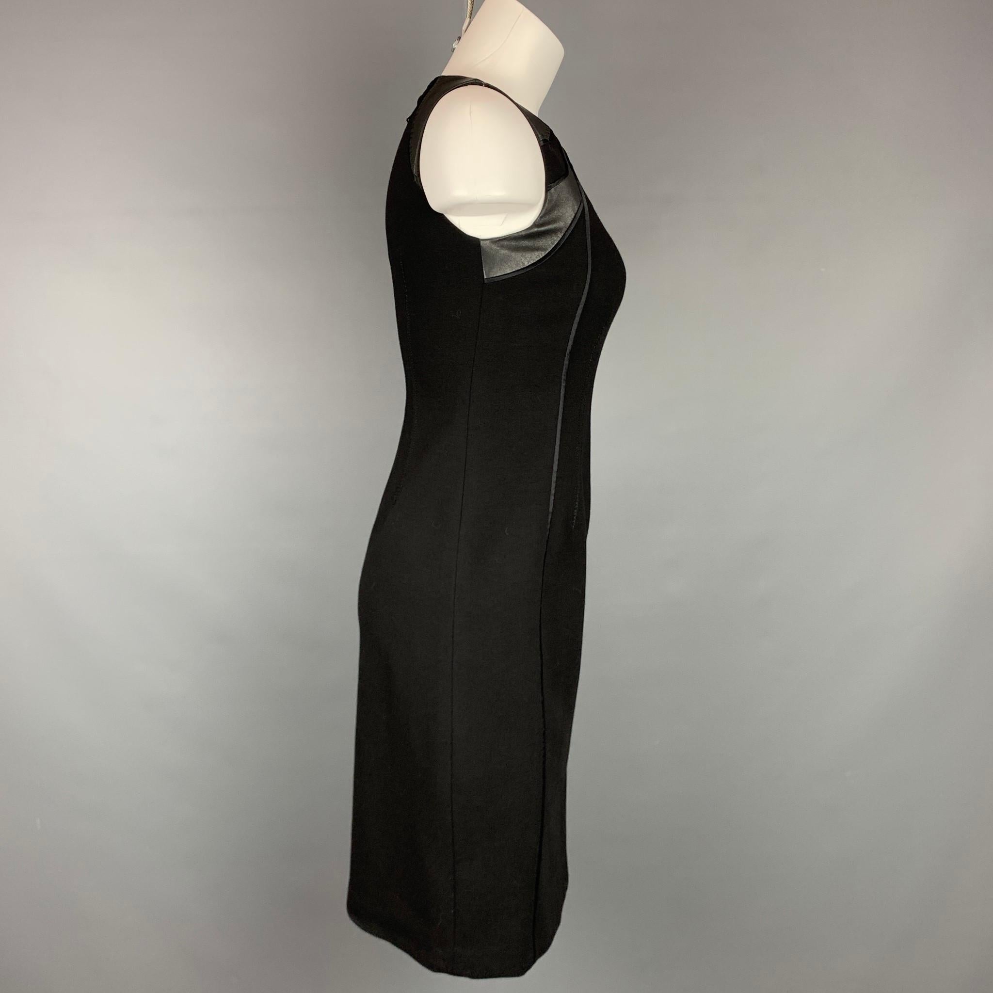 ELIE TAHARI dress comes in a black viscose blend with a leather trim featuring a shift style, sleeveless, top stitching, and a back zipper closure. 

Very Good Pre-Owned Condition.
Marked: US 0

Measurements:

Shoulder: 13 in.
Bust: 30 in.
Waist: 26