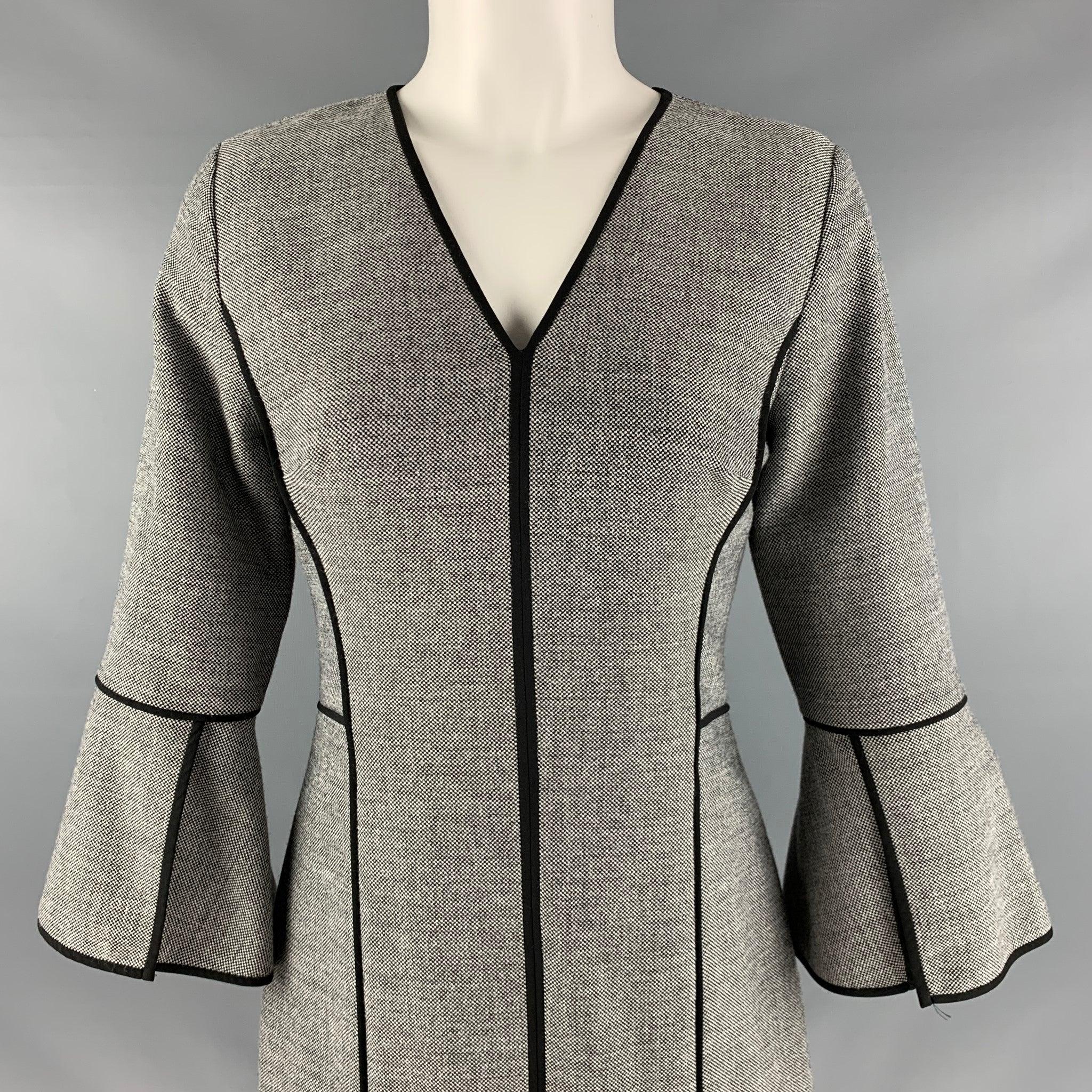 ELIE TAHARI
dress in a black and white polyester blend featuring a nailhead pattern, 3/4 sleeves, V-neck, and black trim.
Very Good Pre-Owned Condition. Minor signs of wear. 

Marked:  4 

Measurements: 
 
Shoulder: 15 inches Sleeve: 18.5 inches
