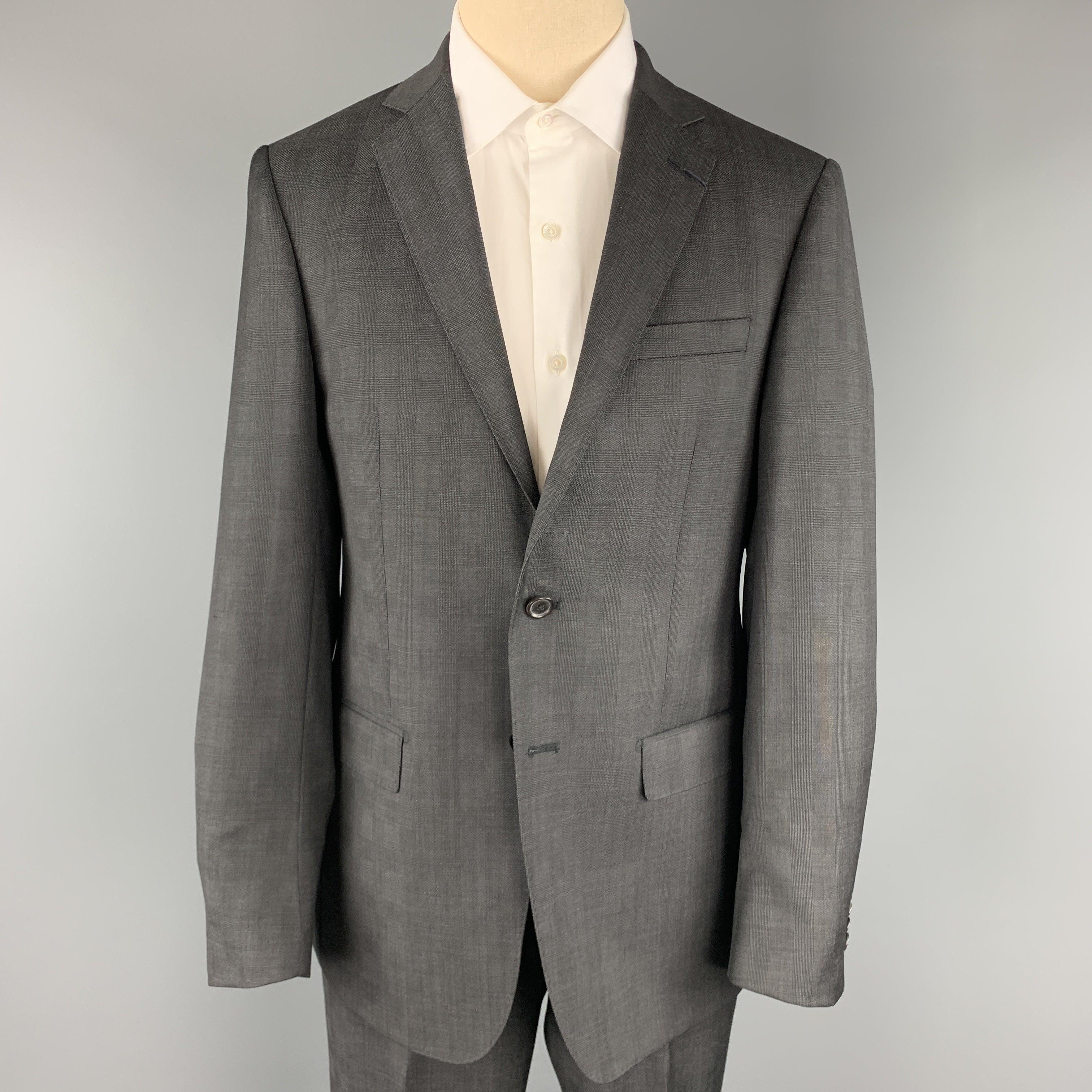 ELOE TAHARI
suit comes in charcoal glenplaid wool and includes a single breasted, two button sport coat with notch lapel and matching flat front trousers. Made in Canada.New with Tags. 

Marked:   40 REG 

Measurements: 
  -JacketShoulder: 17