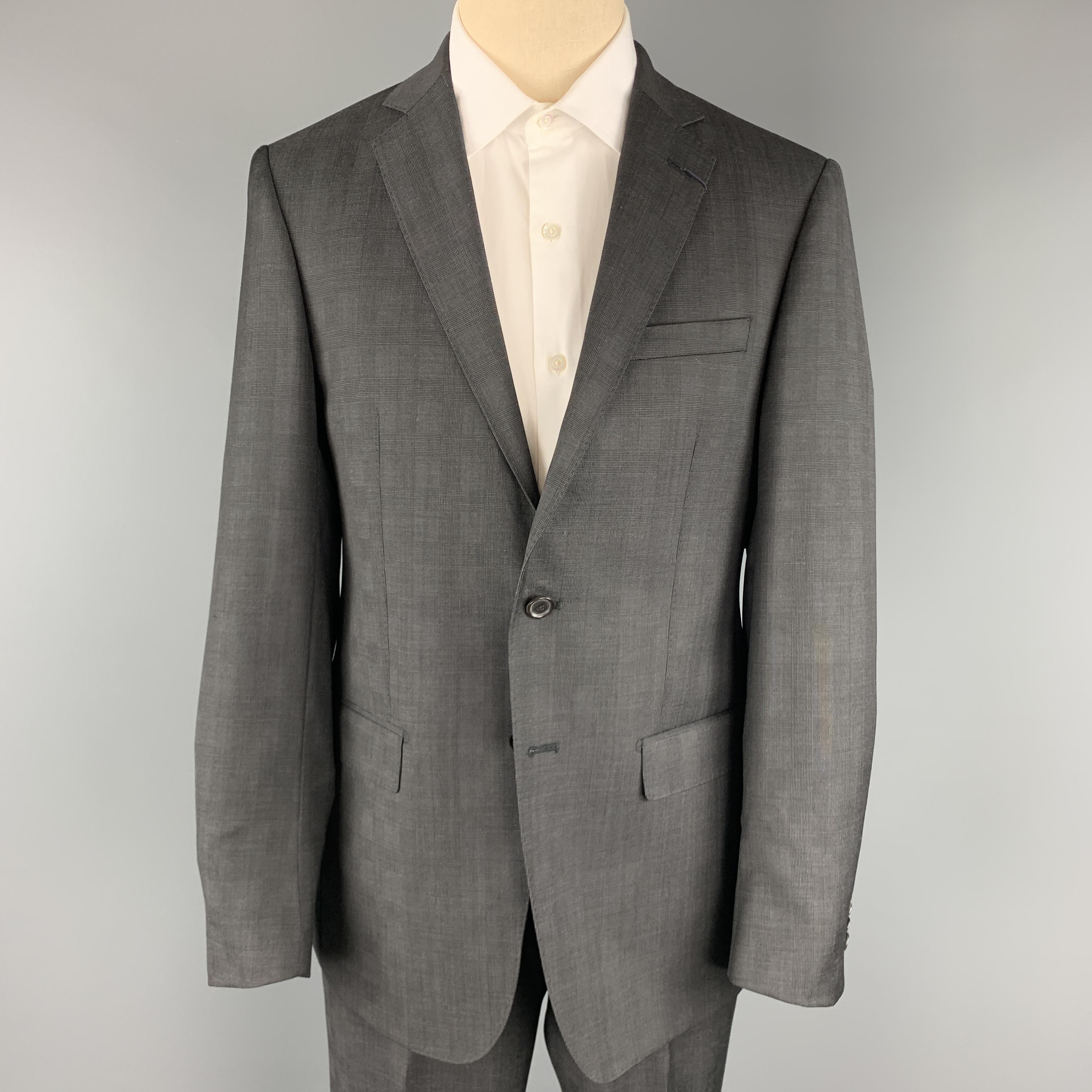 ELOE TAHARI suit comes in charcoal glenplaid wool and includes a single breasted, two button sport coat with notch lapel and matching flat front trousers. Made in Canada.

New with Tags.
Marked: 40 REG

Measurements:

-Jacket
Shoulder: 17