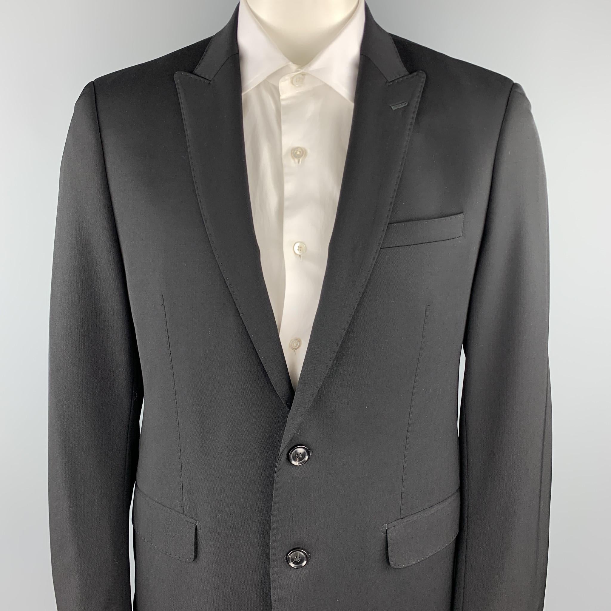 ELIE TAHARI sport coat comes in a black wool with a full liner featuring a peak lapel, flap pockets, and a two button closure.

Excellent Pre-Owned Condition.
Marked: 42 R

Measurements:

Shoulder: 19 in. 
Chest: 42 in. 
Sleeve: 27 in. 
Length: 29.5