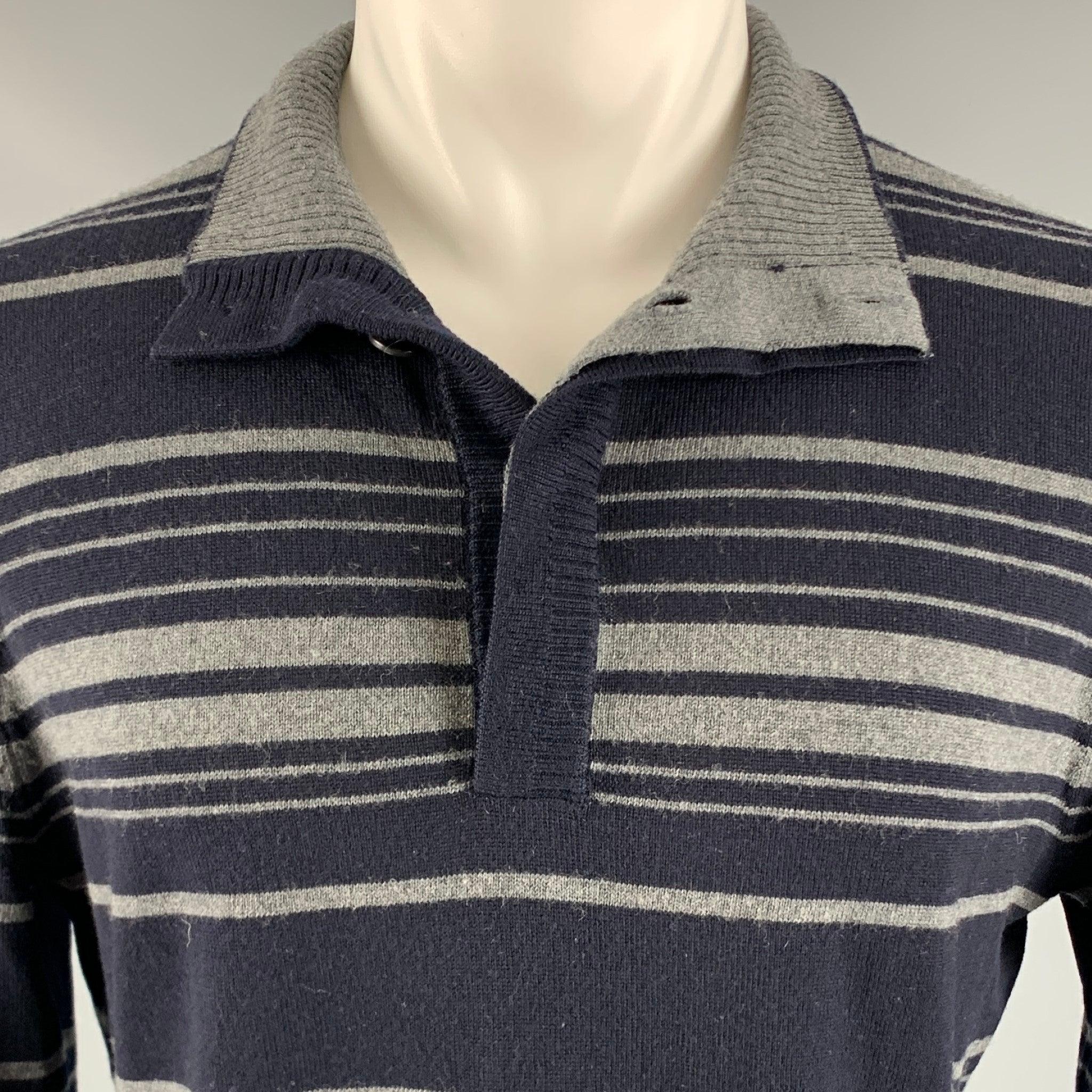 ELIE TAHARI pullover
in a
navy and grey merino wool knit featuring long sleeves, stripe pattern, and a half placket with hidden button closure.Very Good Pre-Owned Condition. Minor mark.  

Marked:   size tag removed. 

Measurements: 
 
Shoulder: 18
