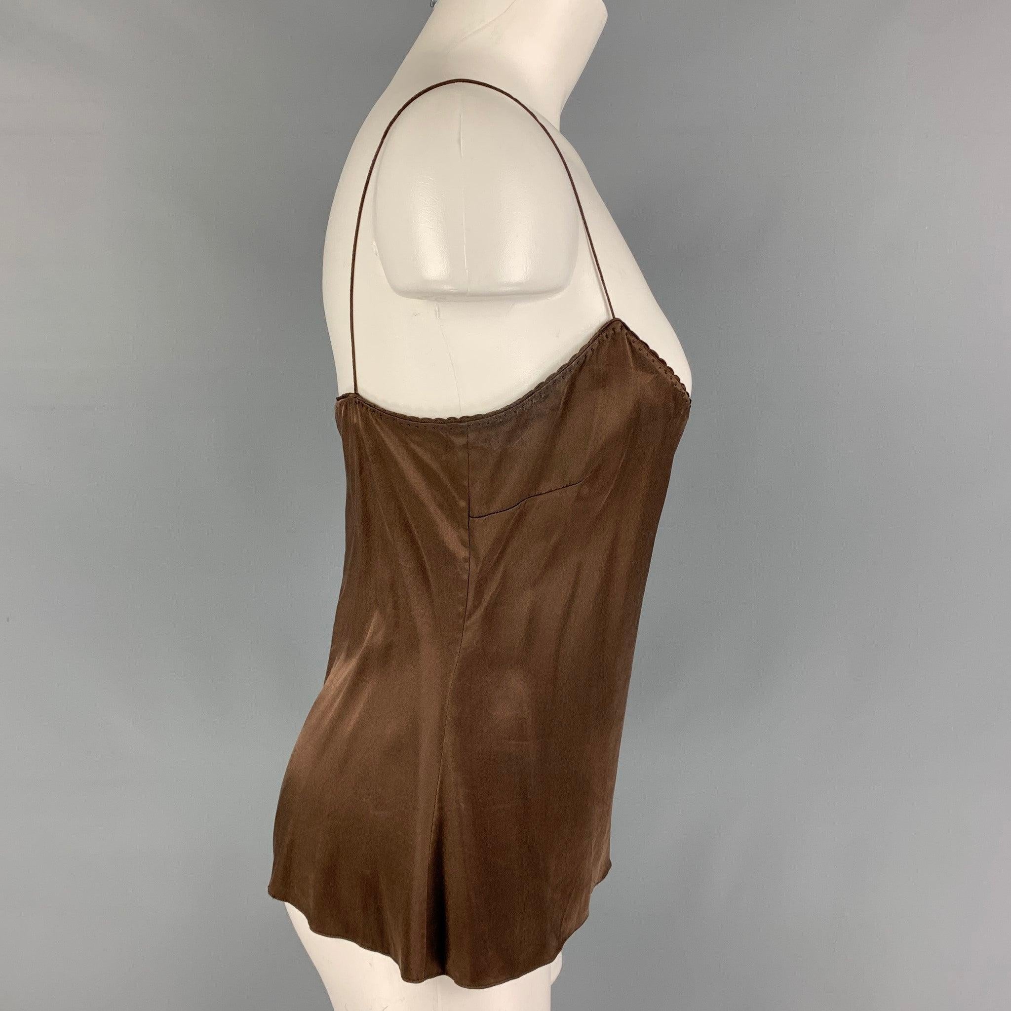 ELIE TAHARI blouse come in brown silk and elastane featuring a camisole style and spaghetti straps. Good Pre-Owned Condition. Light wear and discoloration at underarm. As-is.  

Marked:   S 

Measurements: 
  Bust: 32 inches Length: 16 inches  
  
 