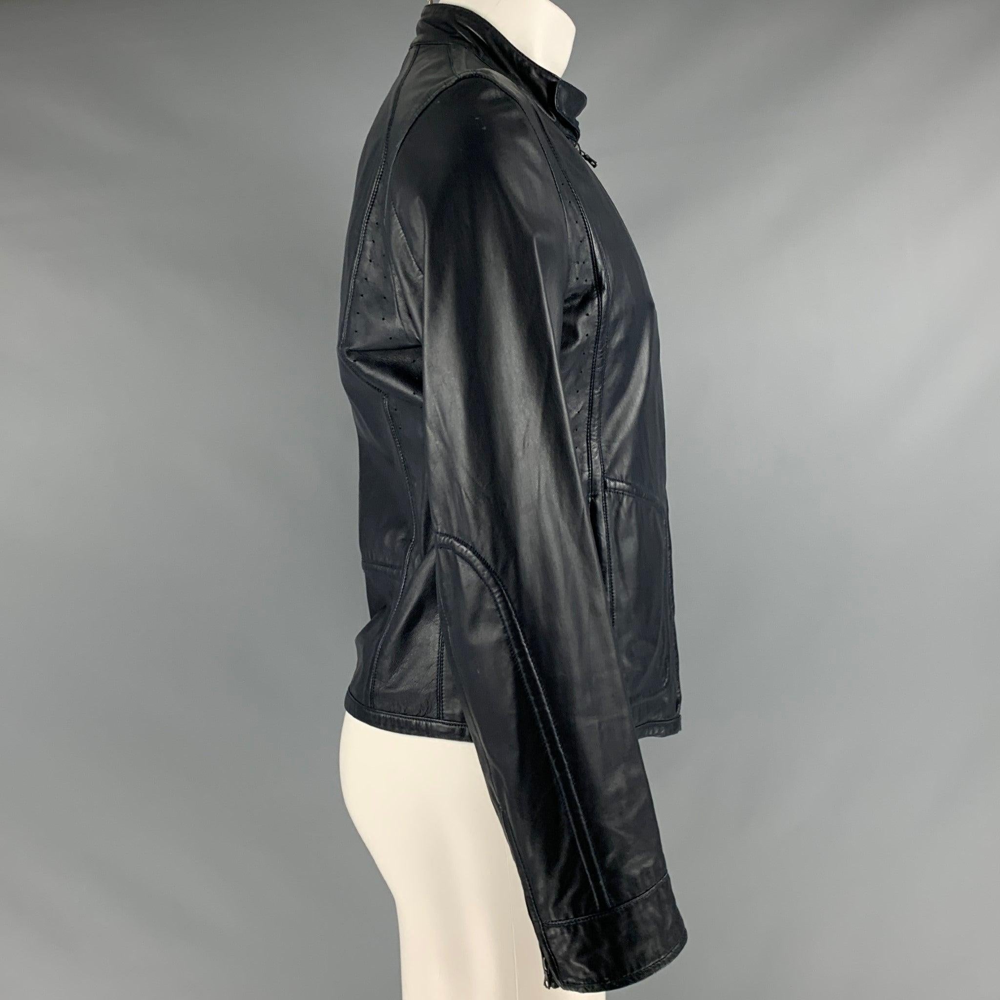 ELIE TAHARI jacket
in a navy leather fabric featuring four pockets and a zip up closure.Very Good Pre-Owned Condition. Minor signs of wear. 

Marked:   size not marked. 

Measurements: 
 
Shoulder: 17.5 inches Chest: 37 inches Sleeve: 26 inches