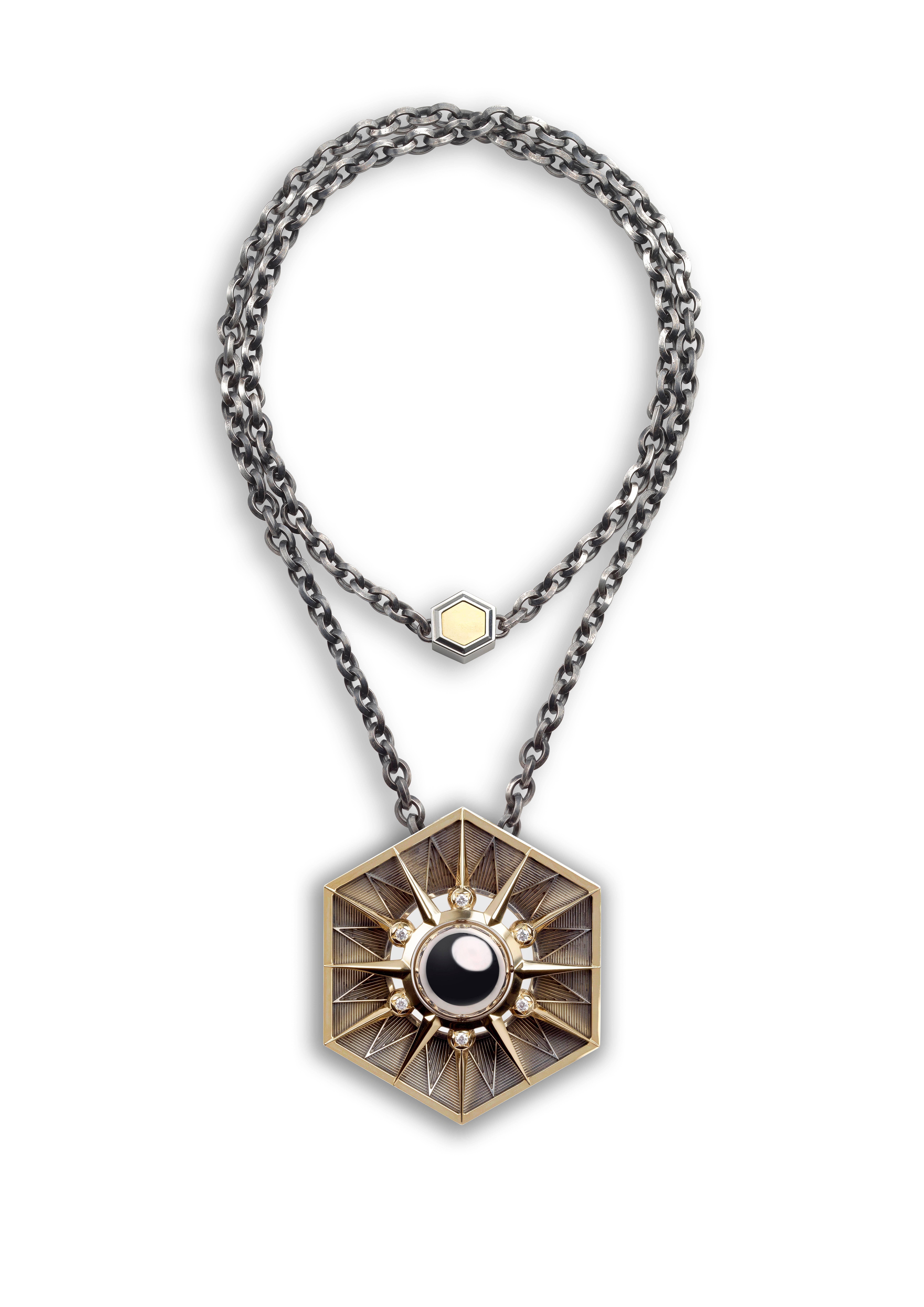 Necklace comprising a patinated silver chain and an octagonal yellow gold pendant. An onyx disc at the centre of a yellow gold star, set in a pivoting half-sphere to be worn two different ways: all gold and silver or gold and onyx. The stars of the