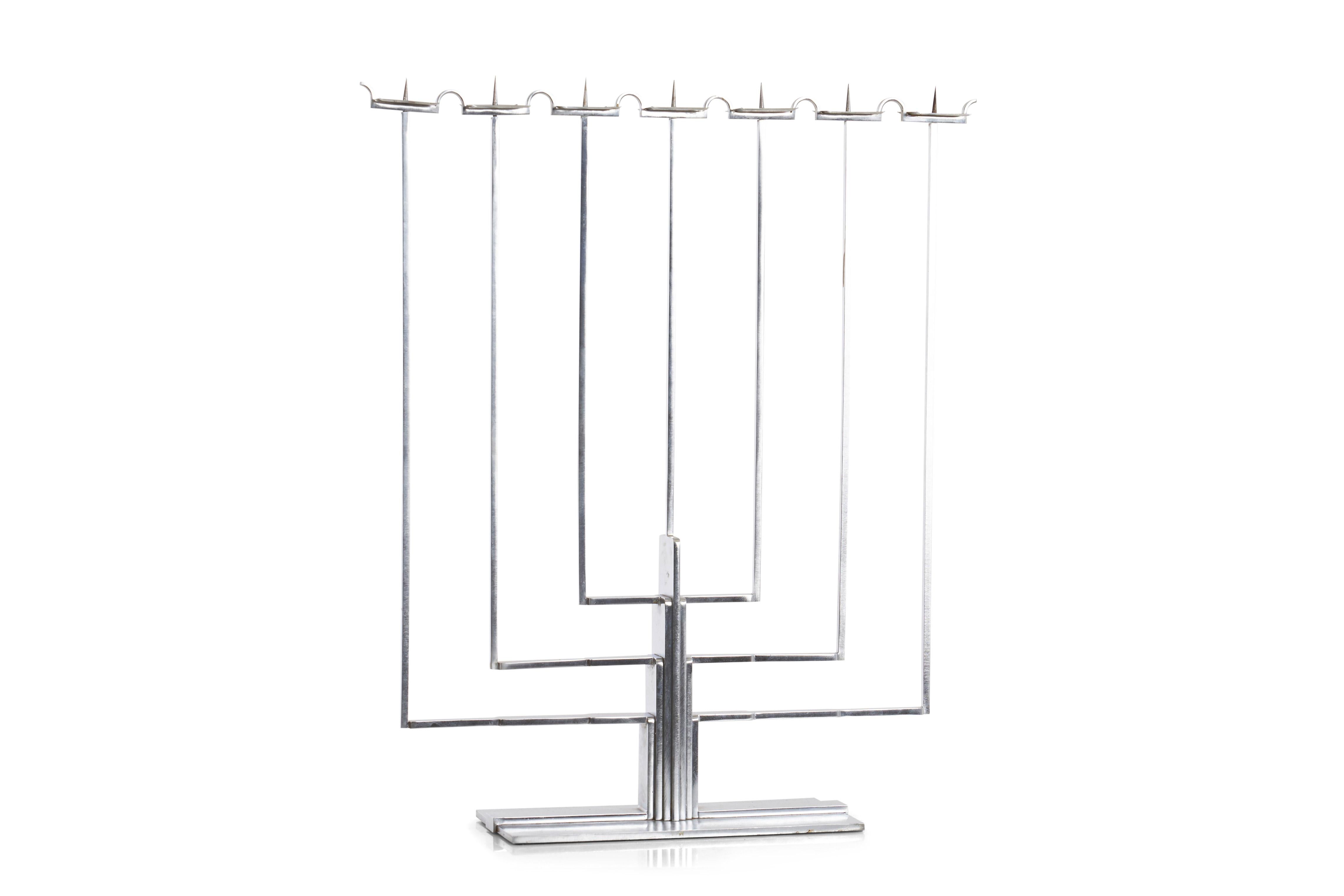 This candelabrum in nickel-plated brass was designed by Swanson in 1935 for the interior of Gordon Menselssohn's home in Bloomfield Hills, Michigan. Over a decade later, Swanson, his wife, Pipsan Saarinen Swanson, and Eliel Saarinen created the