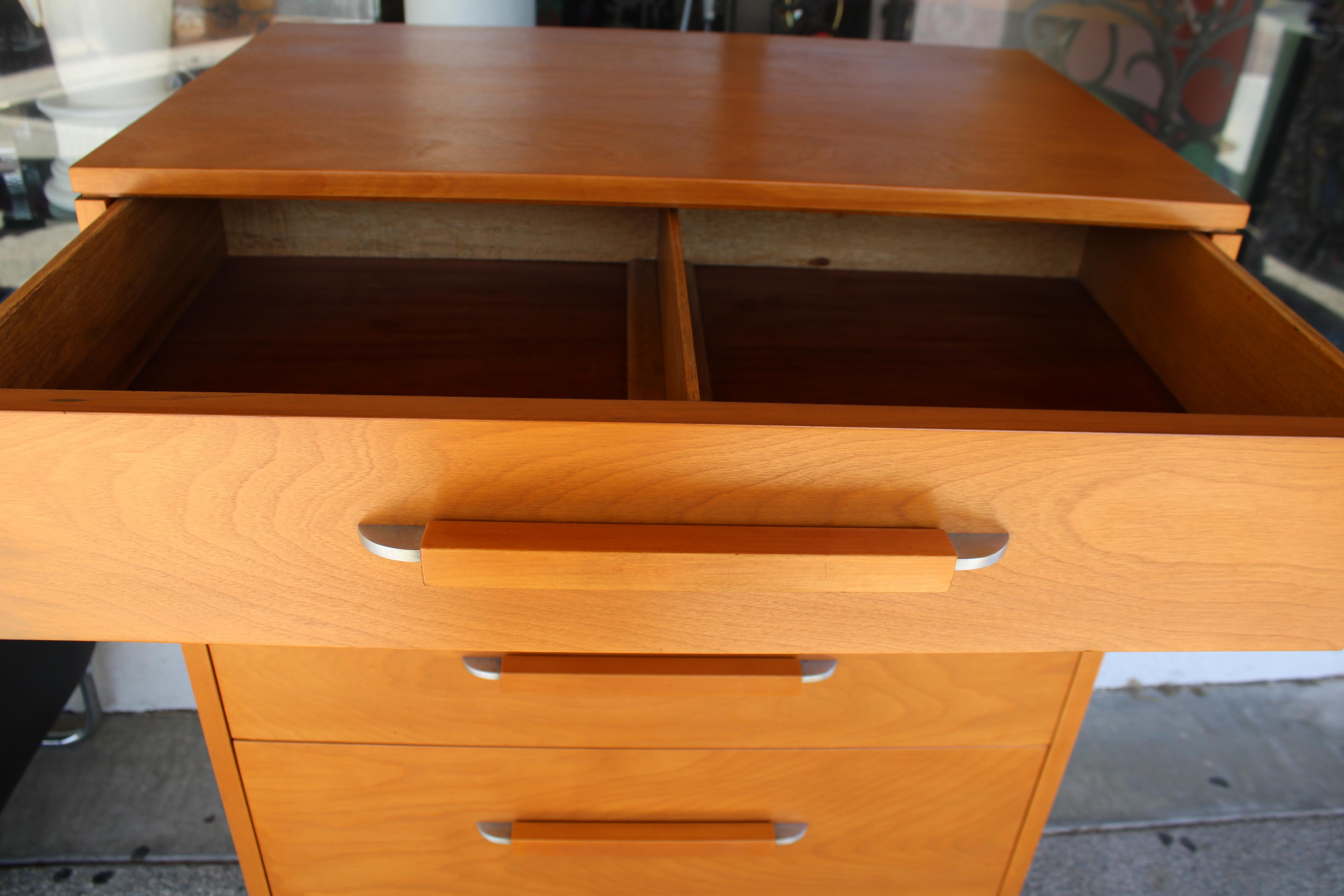 Commode conçue par Eliel Saarinen pour la Johnson Furniture Company à Grand Rapids, Michigan.   Sa conception faisait partie de la collection de meubles Flexible Home Arrangements (FHA).  Placage de bouleau, poignées de tiroir en bois et aluminium