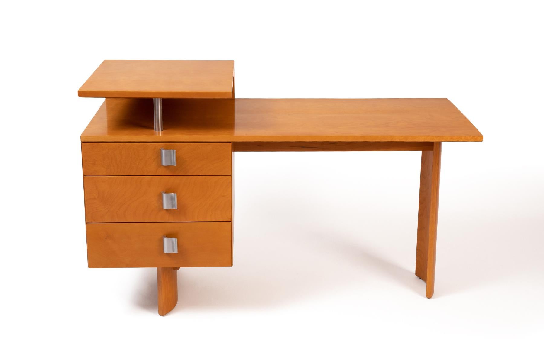 Eliel Saarinen for Johnson desk circa 1948. This rare example executed in birch has three drawers, sculptural s shaped legs and formed aluminum pulls. It has been masterfully restored. Please see our other listings for the accompanying chests from