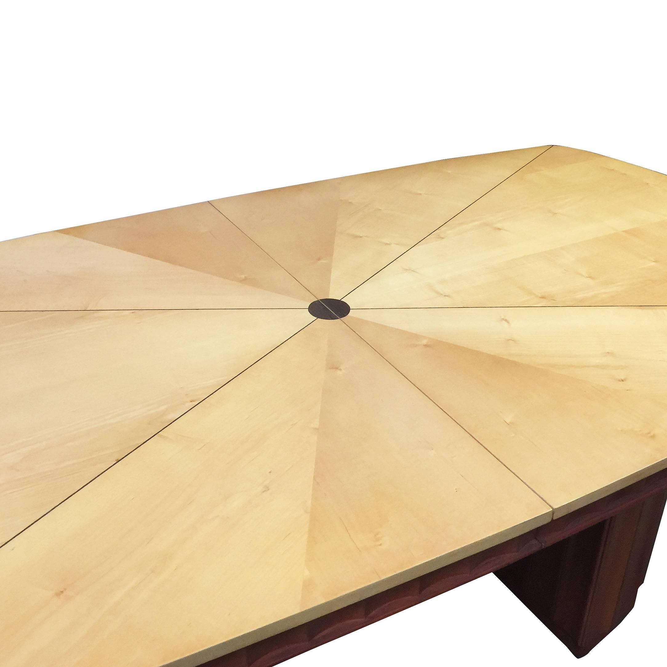 Rare two-tone French Art Deco dining room table with sculpted bases in the style of Eliel Saarinen. The tabletop features a inlay tabletop with dark walnut in strips on a blond surface. 

The top comes with an leaf to expand the table, leaf is