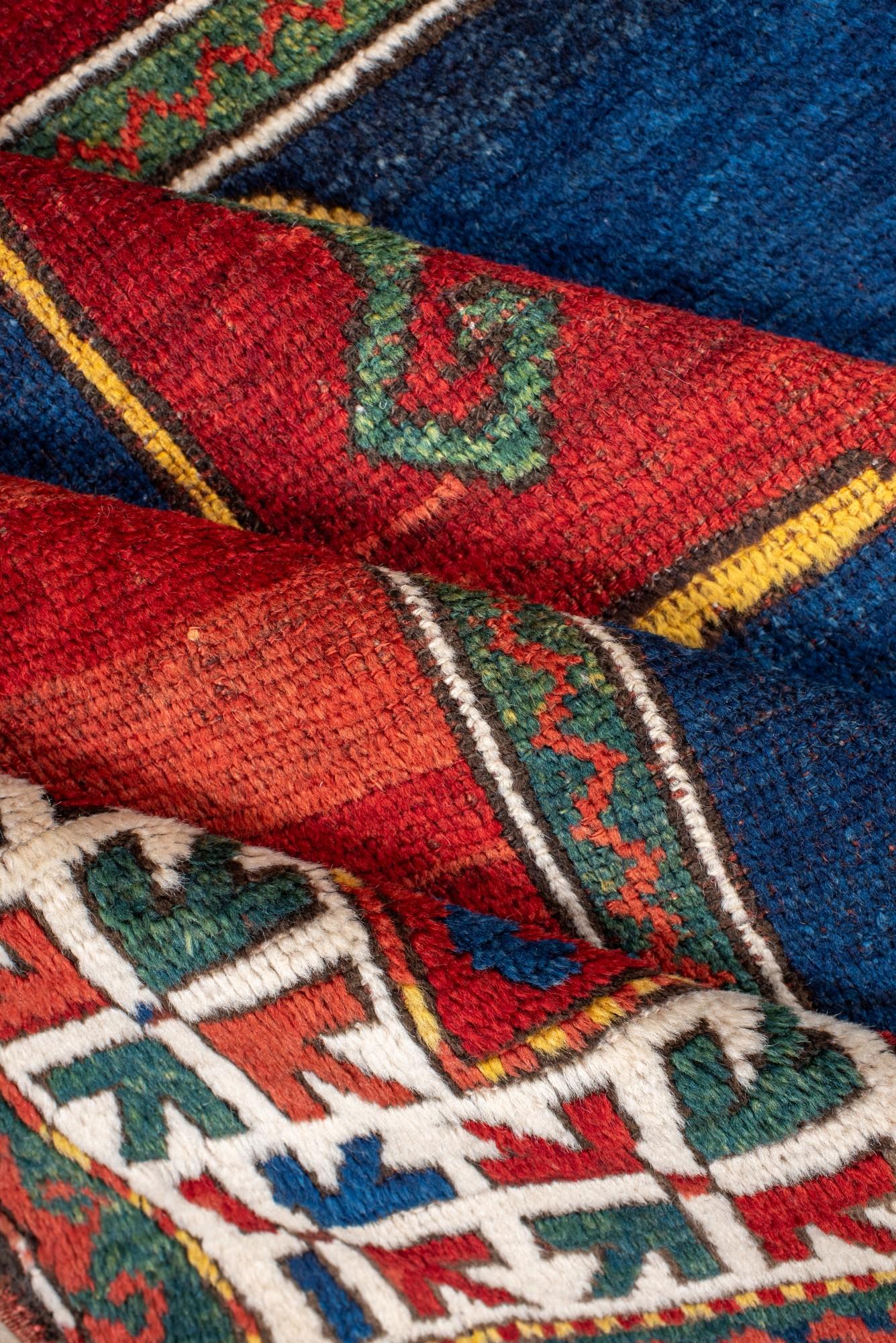 Hand-Knotted Antique Kazak Rug with Rich Blue and Red Colors For Sale