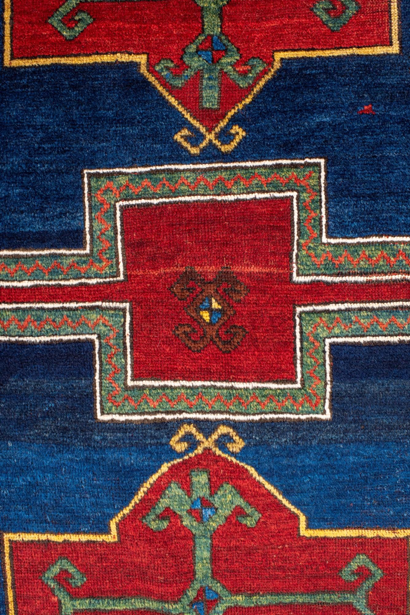 Wool Antique Kazak Rug with Rich Blue and Red Colors For Sale