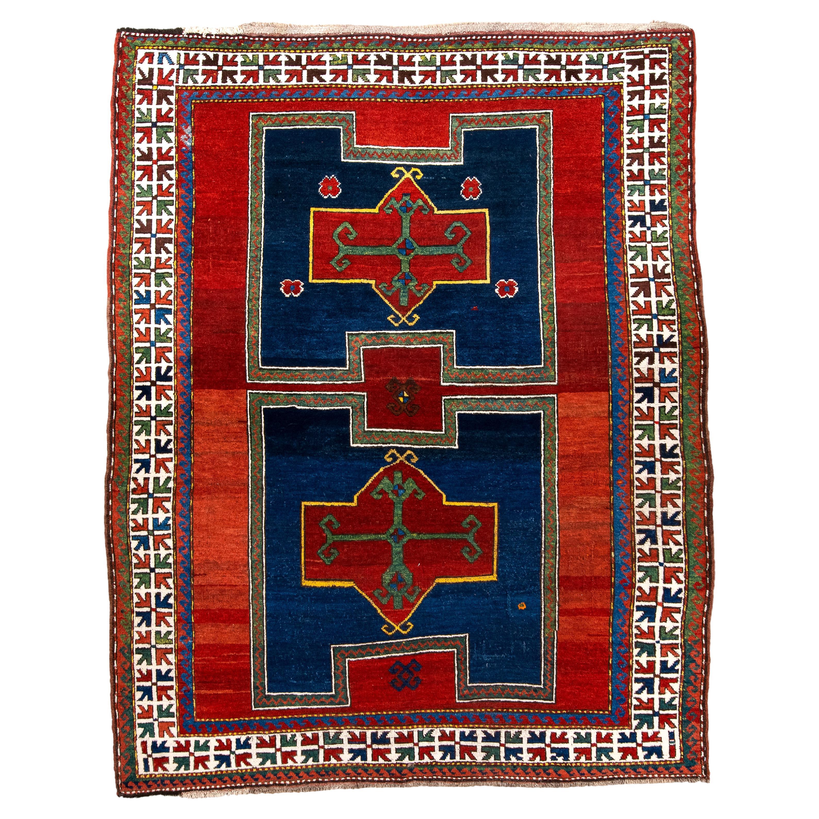 Antique Kazak Rug with Rich Blue and Red Colors For Sale